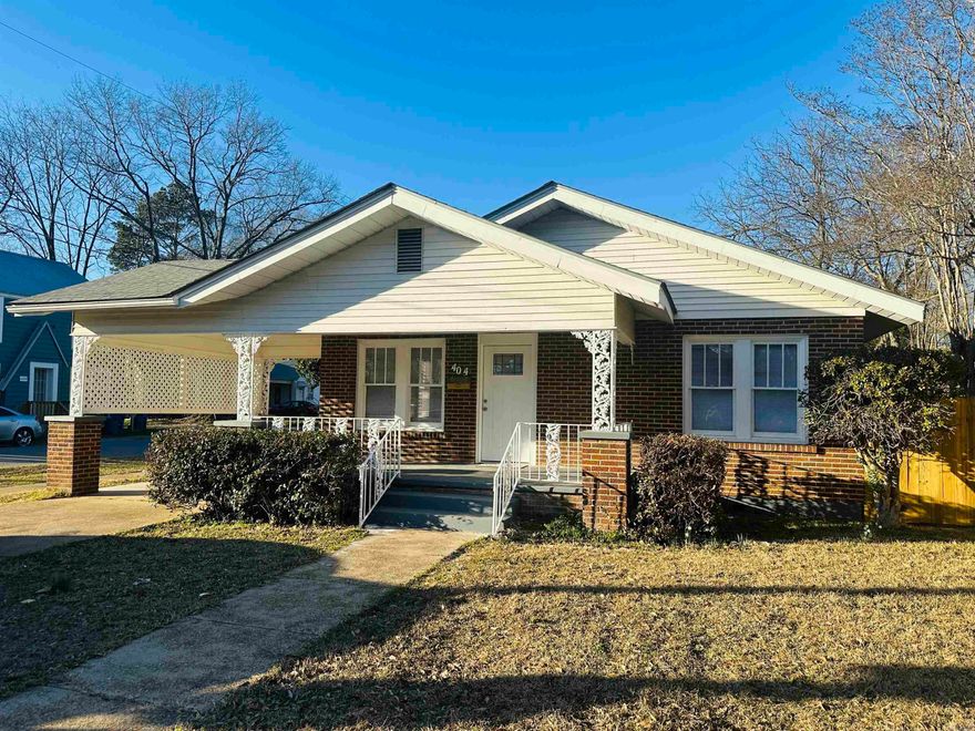 Charming, character, and warmth best describes this home with timeless appeal.  The brick home has been recently renovated but keeps the charm with original exterior details and original wood flooring in the living room, dining room, and bedrooms. Lots of large windows brings in tons of natural light throughout the entire home. 3 nice sized bedrooms with a primary bedroom having an attached bath. Middle room offers a fireplace and could be used for bedroom, den/study, or a playroom. The primary bath features a corner shower and new vanity while the hall bath has a tiled tub/shower combo and a new vanity.  The kitchen has new cabinets, countertops, stove, dishwasher, disposal, a dedicated panty and laundry space with tile flooring. New paint throughout makes the home fresh and ready for a new owner. The backyard has a new wood privacy fence with several double gates making access easy for storing trailers, RV's, boats, etc. The workshop has been painted and has a concrete floor, new window, and double doors for storing mowers, yard tools, or kids play toys.  Seller is offering a transferable home warranty. **Agents see remarks.