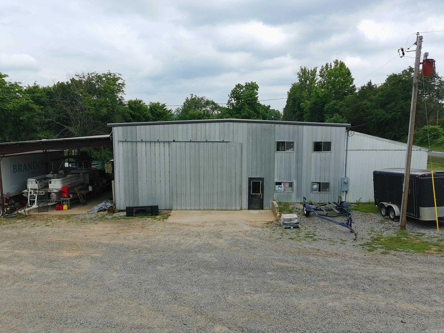 Looking for the perfect property to start a business? Possibly live on site? Look no more! Multiple buildings can be transitioned into unlimited choices of usage!!! The pasture area boasts a pad with a view to built a home, privately tucked behind a grove of trees. The backside of the large buildings (approximately 20 ft x 100 ft) could also be converted into a barndominium with the front side as the shop area for personal or business usage.  There are two rooms/offices upstairs with additional storage for office files, materials, etc. Four rooms downstairs can be finished to your choice of desire.  Building is fully wired for internet. Third, 20 ft x 30 ft building on left property side is fully wired, fully plumbed for a bathroom, laundry and kitchen area, has septic, has 200 AMP electricity and water for RV hookup. This building could easily be made into a one bedroom efficiency unit or office space.  County Records - Building 1 - built in 1991 - 4020 SF, Building 2 - built in 1971 - 5580 SF, Building 3 - 600 SF.  Book your showing today, don't let this rural property slip away. (SQ Footage is approximate, measuring is encouraged.)
