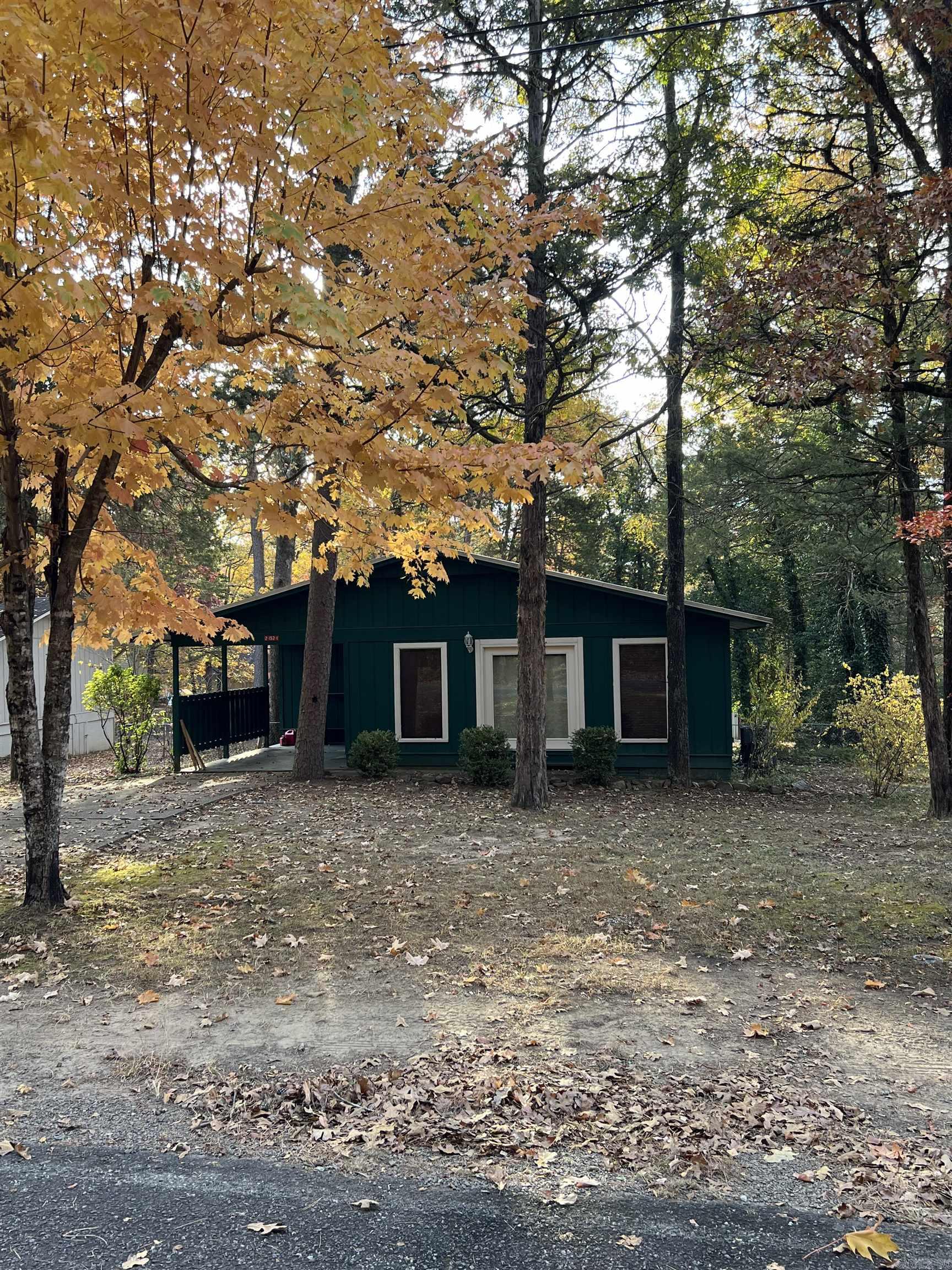 Welcome to your serene escape at Greer's Ferry Lake! This beautiful updated home boasts an open floor plan & plenty of natural light for picture windows in living room. Home was updated in 2021 to add dishwasher and commercial sink. Fresh colors blend beautifully into living room separated by breakfast bar perfect for entertaining. Hallway connects bedrooms & full bathroom w/shower tub combo, new toilet, and large vanity. Off secondary bedroom is a new 200 sq. ft. deck connected to a sheltered outdoor porch accessed by primary bedroom. Fully fenced in backyard has mature trees for shade & privacy. Storage shed for tools or seasonal items. Home is designed for low maintenance comfortable living with upgrades to include split heating system & new metal roof in 2017, oversized AC unit in 2018. This great home is only five minutes from the FFB Marina and ten minutes from the city center. Home is move on ready and can include furnishings if desired. Start enjoying the lake lifestyle right away with two golf courses, ATV trails, tennis courts, bowling alley, private swimming pools, & some of the best lakeside recreation Arkansas has to offer just ten minutes from this home!