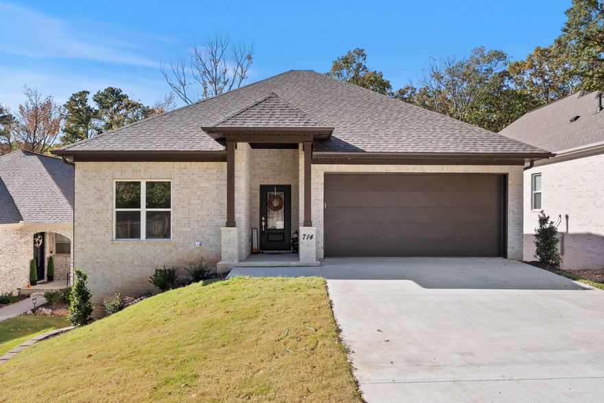 New construction by James Built Homes in Gibralter Heights of West Little Rock, just south of Chenal Parkway and north of Kanis. This thoughtfully designed one-level home combines timeless traditional style with modern features in a serene, private setting. The brick exterior and rich brown accents create handsome curb appeal, while energy-efficient windows enhance both comfort and value. Inside, 9-foot ceilings, wide plank oak hardwoods, and expansive windows create an open, light-filled atmosphere. The spacious great room with color-controlled LED fireplace flows into the gourmet kitchen, complete with GE stainless gas range, microwave, Frigidaire dishwasher, and center island with bar seating. The adjoining dining area opens to a covered deck, ideal for outdoor living. The primary suite is a relaxing retreat with a spa-like bath, dual vanities, a spacious frameless walk-in shower, and a walk-in closet. Two guest bedrooms and a full bath are located privately near the front of the home. Additional features include a laundry room w/ extra storage, designer lighting, LED recessed lights, gutters, partial wood fence, and an insulated garage door.