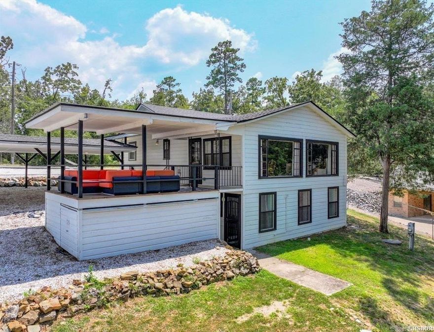 Lakeside jewel!  Completely redone to the highest of standards.  2 Bedrooms 1 bath upstairs.  Gorgeous granite countertops. Separate Downstairs area with living room, 1 bedroom and 1 bath. Downstairs was used as gameroom but has connections for a stove/vent hood and a refrigerator.  Would be an adorable mother in law accommodation or apartment if desired. New HVAC, plumbing, electrical, roof, floors, paint and on and on. 100' on Lake Hamilton with dock and large covered patio.  Most furnishings convey.