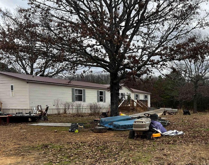 This location will make you feel as if you are on top of the world!  This property has potential for some good country living!   The home is nestled upon the hill, and the view is forever!   Very secluded from the hustle of town.  2000 model mobile home, 2,100 sqft, 4 beds, 2 baths, formal dining, large living rm, large kitchen with breakfast area Come live where you can see the stars forever at night!