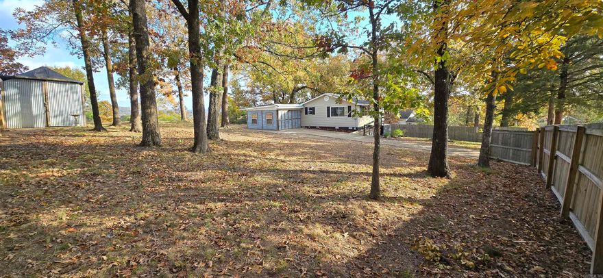Beautifully Updated Home with Workshop, Heated/Cooled Basement Room, and Storm Cellar! Welcome to this move-in ready, beautiful home offering the perfect balance of comfort, functionality, and charm. Nestled among mature trees on a spacious lot with gentle slopes and natural privacy, this property provides a peaceful setting while remaining close to all the conveniences of town. Enjoy unbelievably beautiful panoramic views from the private backyard—both adjacent rear properties are church grounds, enhancing the quiet and open atmosphere. Every major system and finish has been thoughtfully updated for years of worry-free living. Recent improvements include new electrical wiring, updated HVAC system, energy-efficient windows, fresh interior and exterior paint, luxury vinyl plank flooring, remodeled baths, new kitchen appliances, fixtures, and lighting throughout. Step inside to a bright and inviting living area with large windows allowing abundant natural light. The open floor plan flows effortlessly from the living room into a spacious dining area and modern kitchen featuring refreshed cabinetry, solid-surface countertops, and new stainless appliances. Each bedroom is comfortably