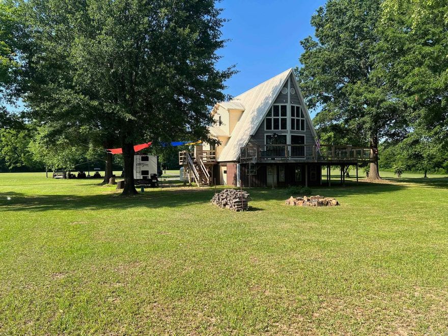 Fantastic Elevated A Frame Home on the Banks of the Arkansas River. 12 private acres on dead end road 200 feet of River Frontage Community Boat Ramp Several out buildings, drilled well and city water,  25 minutes to Little Rock and less to Conway House is a well maintained two bedroom two bath with loft. 4 Car garage below. Nice decks Great Views