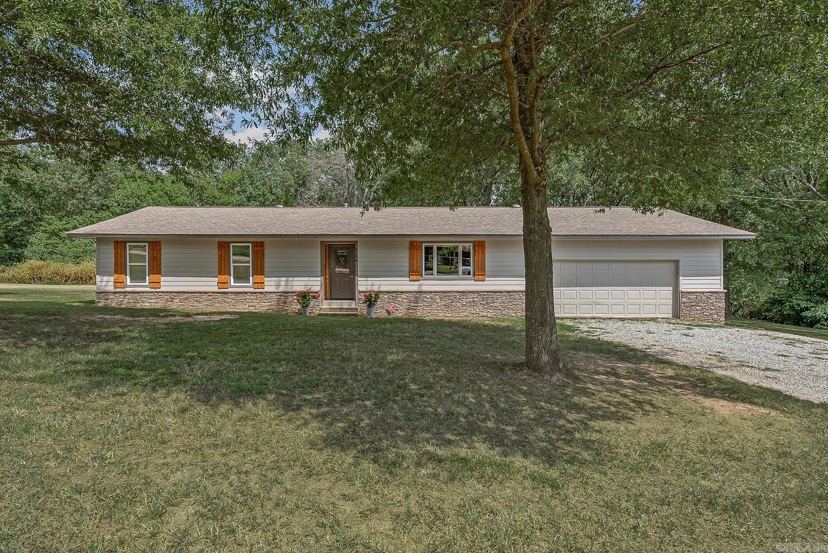 This little gem is awaiting new owners, all new hardy board being painted with stone accents and a new deck being built on back, woods in the back offer a serene privacy along with the house sitting on two lots, offering a little elbow room is always nice! The updates are plenty when you see this kitchen with corian countertops and all luxury plank flooring throughout, updates neutral paint and decor including wood accents at the front door and cypress shutters being made custom for this three bedroom home! Call to view this one fast! Hardy board will be painted mindful gray and trim gauntlet gray. Or if you buy quick you can pick!