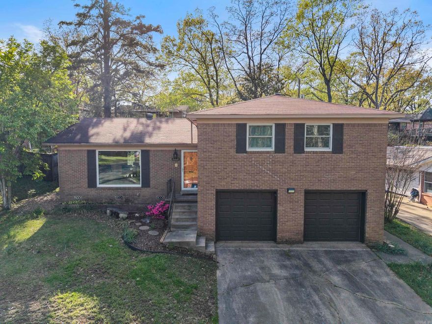 This updated 4-bedroom, 3.5-bathroom home blends classic charm with modern convenience. The refinished original hardwood floors add warmth and character, while the spacious formal living and dining rooms provide the perfect setting for gatherings. The updated kitchen boasts sleek countertops, white cabinetry, and newer stainless steel appliances, with space for a breakfast table. Downstairs, the spacious family room features a cozy fireplace, wet bar, laundry room, half bath, garage access, and direct outdoor entry. Upstairs, you'll find four generously sized bedrooms, including a spacious primary suite with a walk-in closet, en-suite bath, and a new mini split (2022). Additional highlights include all-new Anderson windows (2023) and a brand-new HVAC system (2024), ensuring year-round comfort.