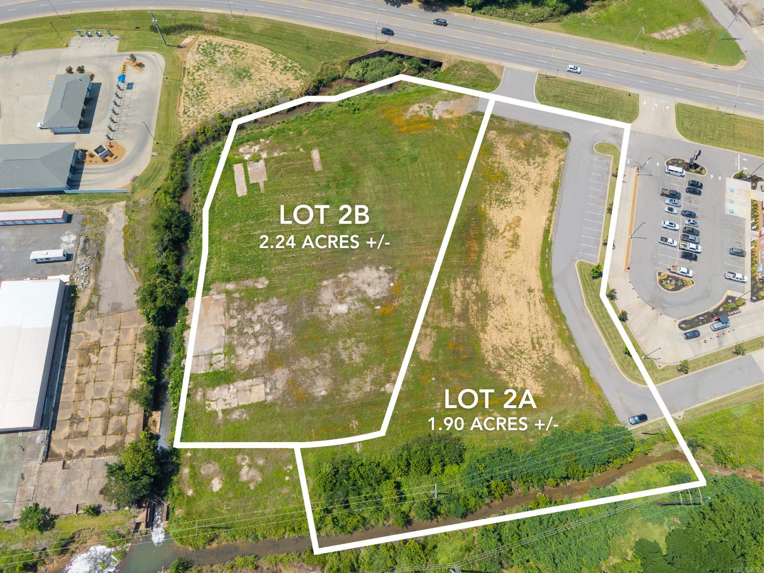 This premier 4.14-acre development site in downtown Searcy presents an outstanding opportunity for commercial investment. With approximately 300 feet of prime frontage along Beebe Capps, the property benefits from exceptional visibility and high daily traffic counts. Zoned C-4, it offers versatile development possibilities, supported by readily available utilities to facilitate efficient construction. Strategically positioned near Harding University, the Walmart Distribution Center, and other major industrial operations, the site is nestled among established businesses, including Slim Chickens, McDonald’s, Burger King, and Topicals Smoothie Cafe. Can be subdivided, Lot 2A, encompassing 1.90 acres, is available for individual purchase or can be combined with the adjacent 2.24 acre Lot 2B for expanded development potential, making this an ideal choice for visionary developers seeking a high-impact location. Lot 2B Phase 1 & 2 Environmental passed in 2025.