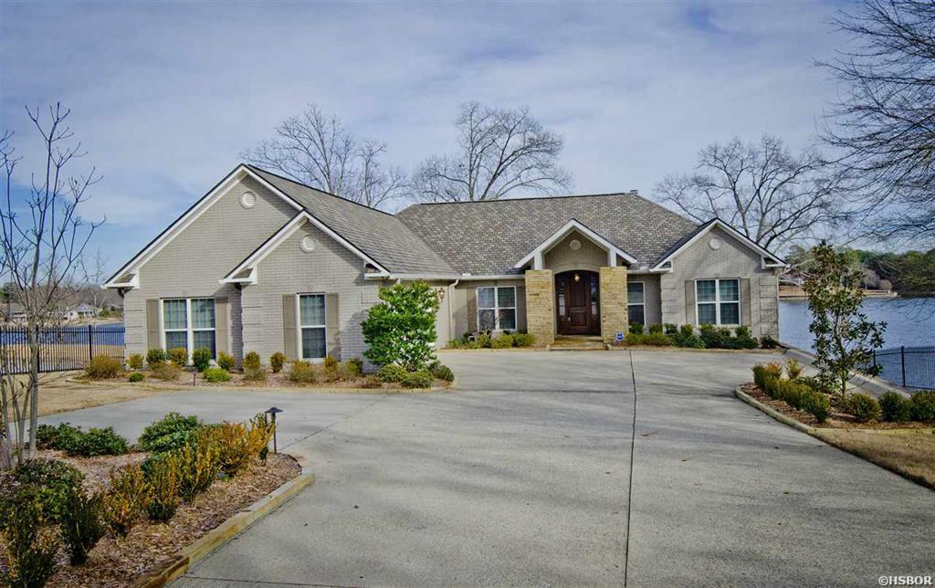 Don't miss this Lake Hamilton home with Amazing views!! This home features custom details in every space. Formal Dining, Large kitchen w/ custom cabinetry & Breakfast Nook. Upstairs features 3 BD/2 Full Baths & 1 Half Bath. Downstairs has Open living area, Fireplace & Full kitchen w/Bar, 2 BD/1 Full Bath. Bonus Room for Storage of lake toys or finish it out for more living space. Outdoor Living Areas are abudant & perfect for entertaining.Gated Entrance. Large covered double dock w/ lifts included.