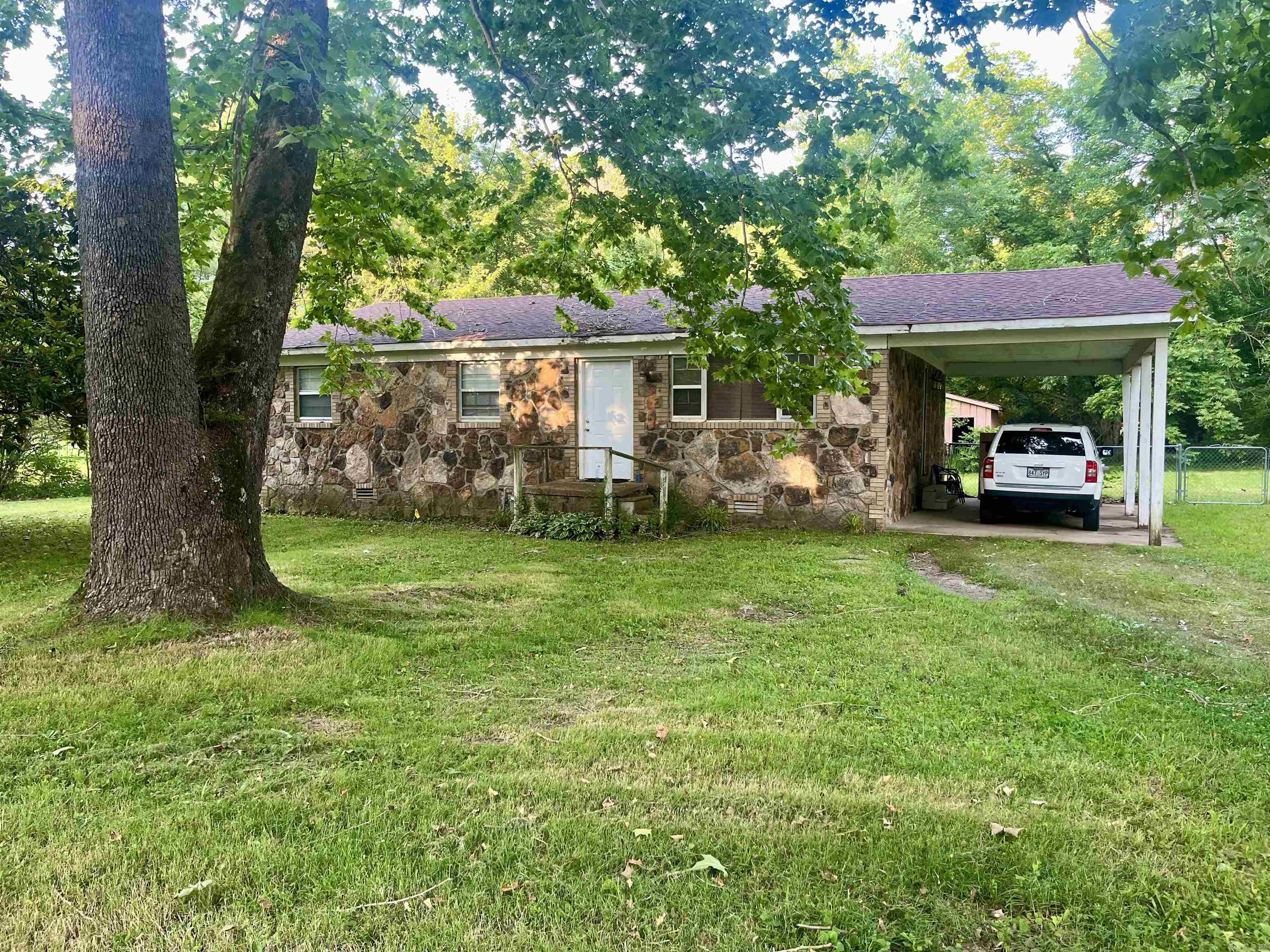 Welcome to Laplaza Acres Subdivision on the West Side of Searcy! This is an older neighborhood that has a creek running through it! This Charming, quaint, rock home has some great features and potential. The living room has wood beams and a large window thats a great place to visit and just chill. The open kitchen with the dining area is a great place to visit while preparing for your family, friends, or by yourself. Step outside to the large fenced backyard where you can enjoy the gorgeous trees bird watching while relaxing and drinking some coffee. This home also has a storage building where you can do some projects or even have it for the kids playhouse! You will love the breathtaking Magnolia Tree and the Hydrangea Bush! This home also has a newer roof and hot water heater! This is a great place to ride bikes, walk, raise your family, or just retire and enjoy the peace and quiet! ` Sold as is! Schedule a showing today!
