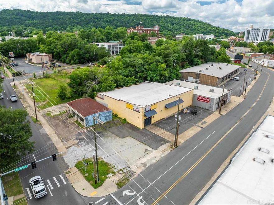 This historic property, located at 454 Broadway Street and 208 & 214 West Grand Avenue in Hot Springs, Arkansas, offers over 8,000 square feet of versatile commercial space on just over one acre of land. Built in 1939, the main two-story building exudes timeless charm with original cut redwood construction and expansive interiors that are ideal for a range of uses, including boutique hotel, retail, office, or entertainment venues. Zoned C1 and situated within a Federal Opportunity Zone, the site provides significant investment advantages. The property boasts a combined 620 feet of road frontage, including an impressive 307 feet along high-traffic Grand Avenue, which sees approximately 20,000 vehicles per day—ensuring maximum visibility and accessibility. Located just steps from major hotel chains and the vibrant downtown district, this site is strategically positioned in one of Hot Springs' most desirable and high-demand development corridors. Whether you’re a developer or investor, this is a rare opportunity to revitalize a landmark building in a prime, high-exposure location.  Great Owner Finance Opportunity!