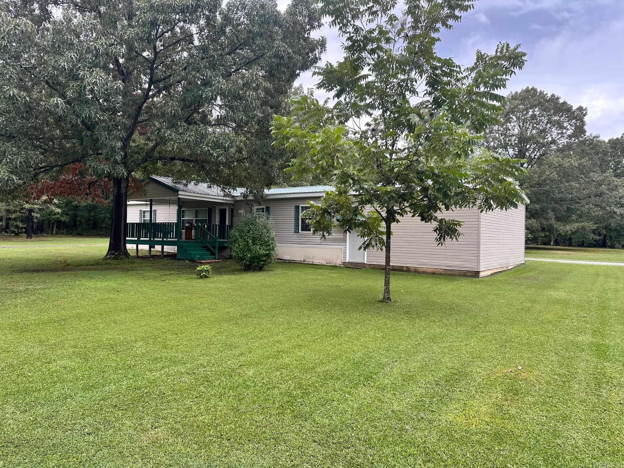 Neat 3 Bedroom 2 Bath Double-wide mobile home on 2.66 Acres. Metal roof is 5 years old. Enjoy the large front porch addition and park your car in the dry in the attached carport. Nice eat in kitchen with plenty of cabinets and counter space plus a center island. Primary bath has a soaker tub and a separate stand-up shower. Enjoy the quiet county life while feeding the wildlife in the back yard. Freeway access is only minutes away. Financing will be Cash or Conventional. See Agent Remarks
