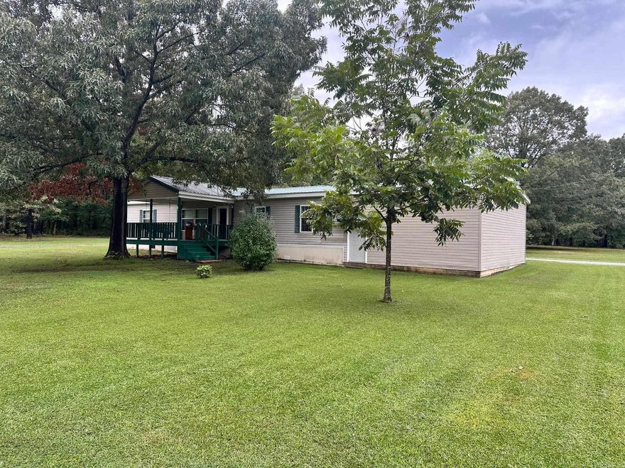 Neat 3 Bedroom 2 Bath Double-wide mobile home on 2.66 Acres.  Metal roof is 5 years old.  Enjoy the large front porch addition and park your car in the dry in the attached carport.  Nice eat in kitchen with plenty of cabinets and counter space plus a center island.  Primary bath has a soaker tub and a separate stand-up shower.  Enjoy the quiet county life while feeding the wildlife in the back yard.  Freeway access is only minutes away.  Financing will be Cash or Conventional.  See Agent Remarks