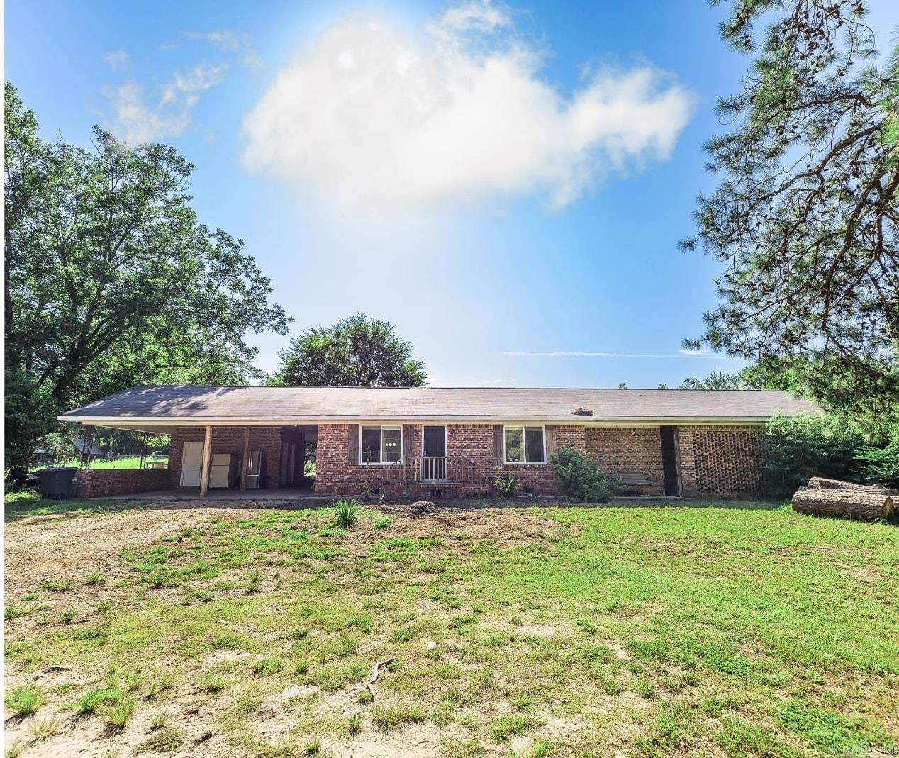 Beautifully updated home on acreage! Open floor pan with a modern and tasteful farmhouse approach. From the minute you walk in the door, you'll feel right at home with the quality workmanship with a nod to rustic charm. The primary bedroom features high ceilings with a more than generous walk-in closet, barn wood feature wall, and spacious bathroom. Also included in the heated & cooled space is the sunroom off the laundry room. Don't miss the finished bonus area under the carport which features central heat & air and a 1/2 bath. The property also includes a 20'x40' barn with electricity and a thick slab foundation. Cross fencing enhances the use of the property if you are seeking homesteading and livestock opportunities! Improvements made in 2017: new roof, new windows (except in sunroom), new septic system, new CH/A, new electrical, new plumbing (except in bonus room), new sheet rock through out, new flooring, new vanities, new tubs, new fixtures, new cabinets, new doors, new appliances, granite countertops, and beautiful, rustic wood accents.