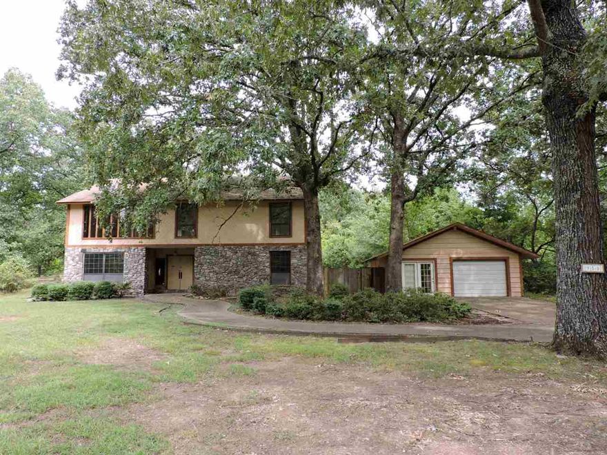 Spacious two level rock and frame ranch style home nestled on acreage within the Fountain Lake School District. Home features 3 bedrooms, 2 full bathrooms, 2 partial baths, central heat, central cool, detached one car garage with storage and fenced backyard with pool. Two bedrooms, 1 full bathroom, 1 partial bath, custom kitchen, dining room and laundry room on main level. Large living room, bedroom with full bathroom and partial bathroom on upper level.