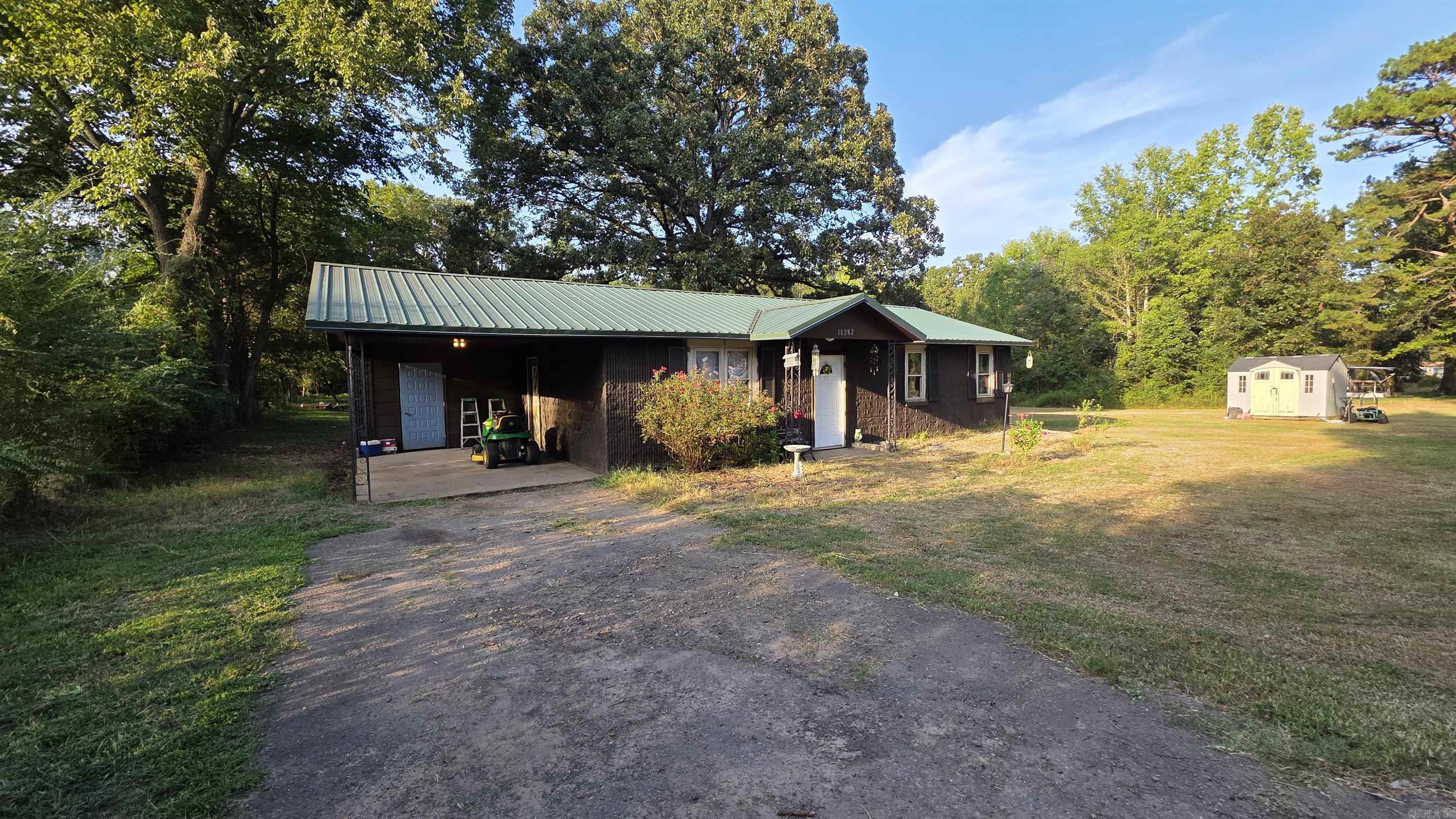 3 bedroom, 1 bath home on 2.5 acres. Enjoy a private walking trail and firepit in the woods behind the house. Features a dedicated laundry area with washer and dryer that convey. The large yard includes a storage building and ample space for outdoor activities. Bonus: John Deere riding lawn mower conveys. Open concept kitchen, dining, and living area. Refrigerator included. Roof installed in 2020, HVAC in 2021, water heater in 2019, and the septic system was new in 2019 and pumped in December 2024. Grill and trampoline to convey as well.