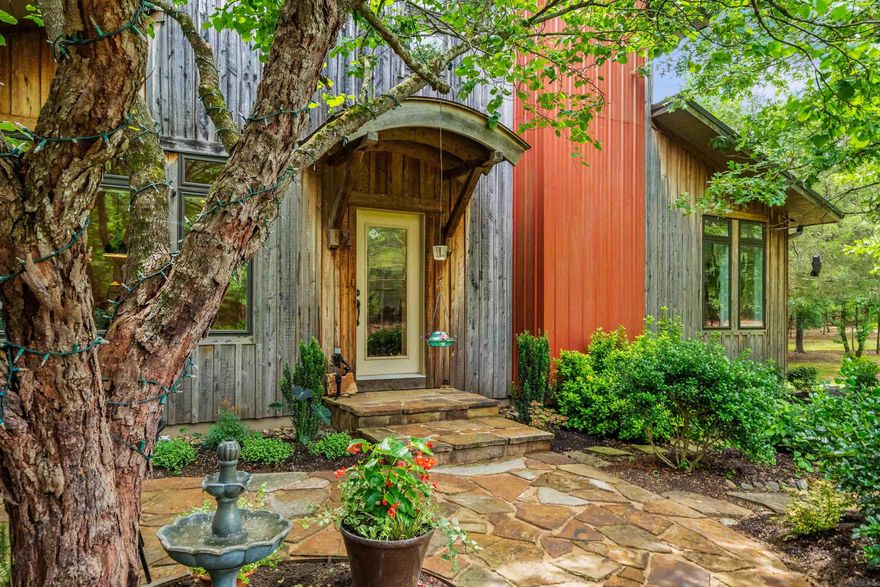 Discover peaceful country living in this energy-efficient, architect-designed, 3 bedroom 3 bath home set on 42 acres of natural beauty. Thoughtfully crafted for comfort and sustainability, this one-of-a-kind property blends modern efficiency with the tranquil charm of the outdoors. Step onto the expansive back porch and take in stunning views of the serene backyard, where wildlife is abundant—deer graze, birds sing, and baby owls can be seen growing in their own dedicated owl house. Several small creeks meander through the property, enhancing the peaceful ambiance. Wander the private trails through mature woods or relax in the beautifully landscaped yard. A large workshop with an attached garage provides ample space for projects, while a greenhouse allows for year-round gardening. There's even covered parking for an RV or boat. Home features cedar exterior, hickory hardwood floors, soapstone countertops in kitchen, filter system for well and backup propane generator. (these are just a few) Whether you're seeking a quiet retreat, a place to explore nature, or a property with room to grow, this unique homestead offers it all! (more info in associated docs)