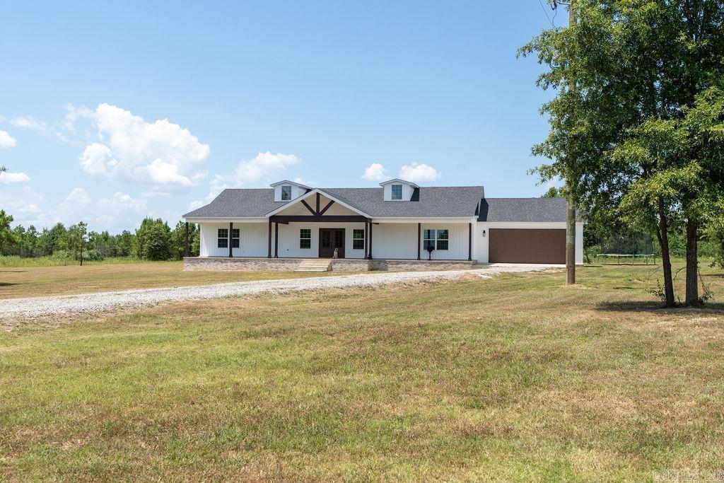 Discover this beautiful, newly built home nestled on 4.06 acres in a peaceful country setting, yet conveniently close to Hwy 64 and a variety of amenities. Offering 2,244 sq ft of spacious living, this 4-bedroom, 2.5-bath home features a stunning custom kitchen with elegant cabinetry, quartz countertops, and a large island with a breakfast barāperfect for gatherings. The open-concept design seamlessly connects the kitchen, living, and dining areas, highlighted by a cozy gas fireplace. The primary suite provides a private retreat with an ensuite bathroom featuring a standalone tub and walk-in shower. Guests or family members will enjoy the separate side of the house, which includes a hallway/sitting area ideal for entertainment or a kids' play space. The laundry room boasts custom cabinetry, ample storage, and a convenient walk-through from the attached two-car garage. Spacious front and back porches, totaling 2,000 sq ft, are perfect for relaxing or entertaining while overlooking lush pasture land. Stylish board and batten siding and a double front door add curb appeal. Don't miss this exceptional propertyāyour dream country home awaits!