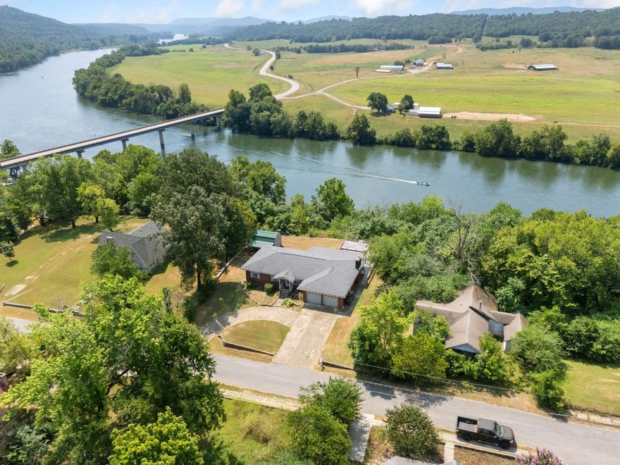 This charming 3-bedroom, 2-bath home in Calico Rock offers year-round views of the White River and the iconic Hwy 5 bridge. Sitting on two lots with city utilities and paved street access, it combines comfort with convenience. Inside, you’ll find wood and tile floors, an updated kitchen, and modernized bathrooms, creating a move-in ready feel. Step outside to the large deck where you can relax and take in  river and countryside views in every season. A rare opportunity to own a river-view property in the heart of Calico Rock, this home blends small-town charm with natural beauty.