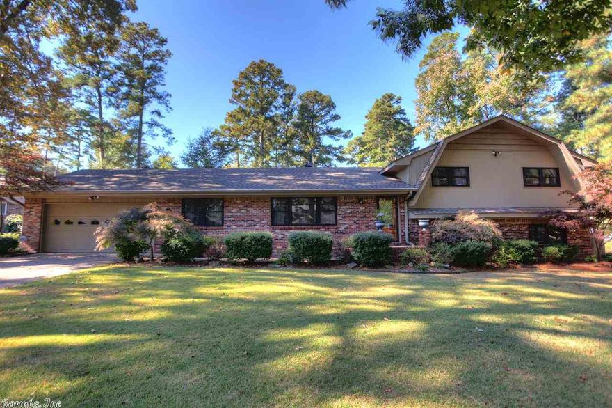 Gorgeous Foxwood home with many modern updates.  Stained Concrete floors in the large bonus game room and downstairs bedroom.  3 Full baths.  Hardwood flooring in remainder of house.