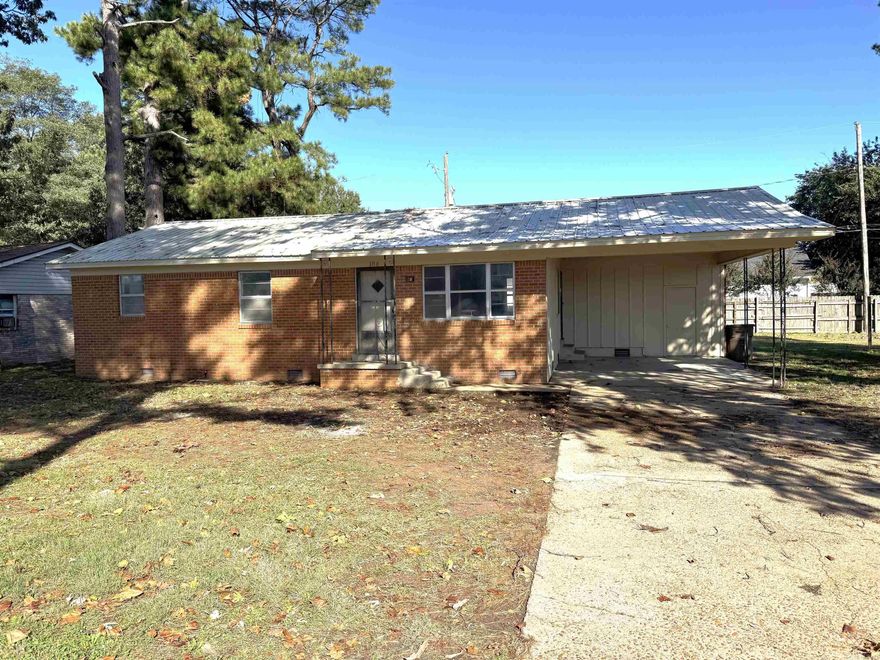 Looking for a move-in ready home with great updates?  This 3-bedroom, 1-bath gem has it all - a metal roof, new gutters, and a flat yard perfect for kids or pets.  Inside, enjoy fresh paint, new LVP flooring in the kitchen, dining and family places plus soft carpet in the bedrooms.  The kitchen features an newer stove (2022) , and the water heater was replaced in 2021.  You'll love relaxing in the spacious family room or parking under the convenient 1-car carport.  This home blends comfort, style and value--come see it before it is gone.