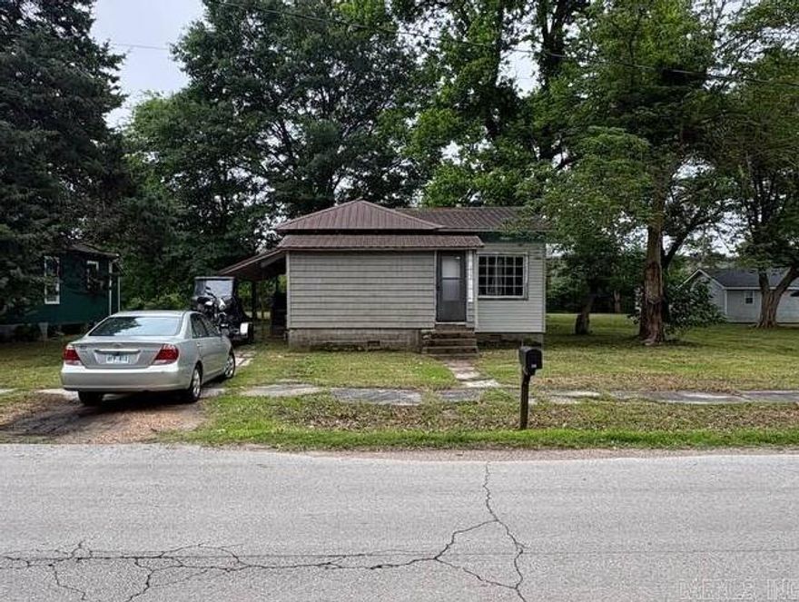 Cute little project Bungalo with a metal roof.  Some nice wood floors inside, some newer kitchen cabinets. Newer exterior doors. Ready for new owners to take it to the next level.  Sits on a double lot with lovely shade trees.  Being sold as-is.