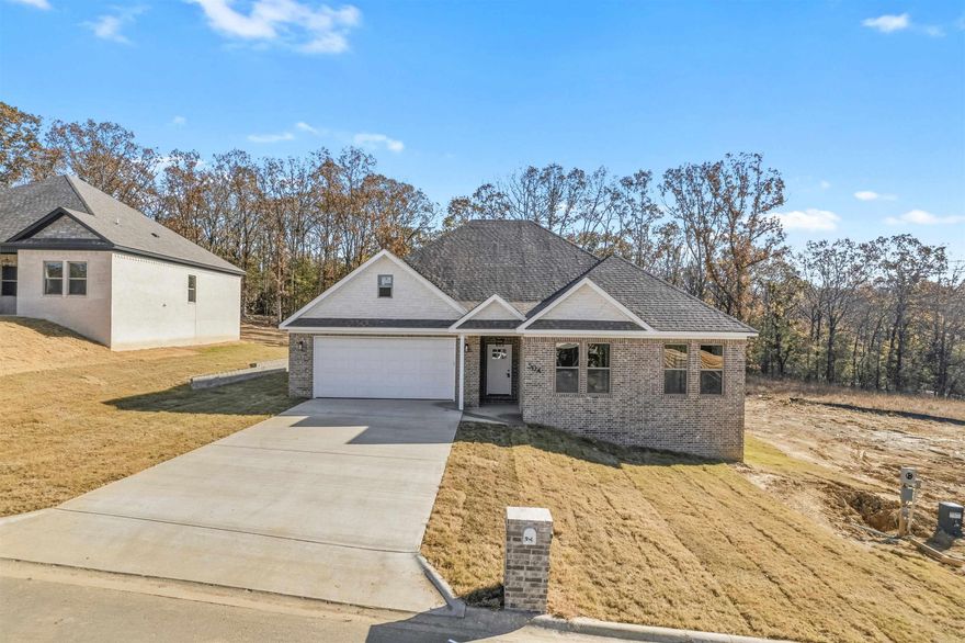 Welcome Home to this Stylish 4-Bed, 3-Bath home in George's Crossing! This gorgeous all brick home offers so much you must see in person! Do not forget the large lot with trees behind too. This home offers an ideal blend of soothing neutral tones w/just the right accents added throughout the home. The home boasts a large foyer from the front door to the living room. The living room opens up and is the center of the home. This ultra open concept is made for family memories, entertaining and easy flow getting about in the home. The stone countertops, tile backsplash and stainless appliances add just the right glitz too! Enjoy a backyard view from the dining room or step out onto the covered back patio too. Stepping into the bedrooms and bathrooms you will be impressed with the luxury vinyl flooring and spacious rooms. The bathrooms all are well appointed and show off a nice light and dark contrast that is just enough to grab your attention to the classy design.  Do not miss out on this stunner of a home! See Agent Remarks.