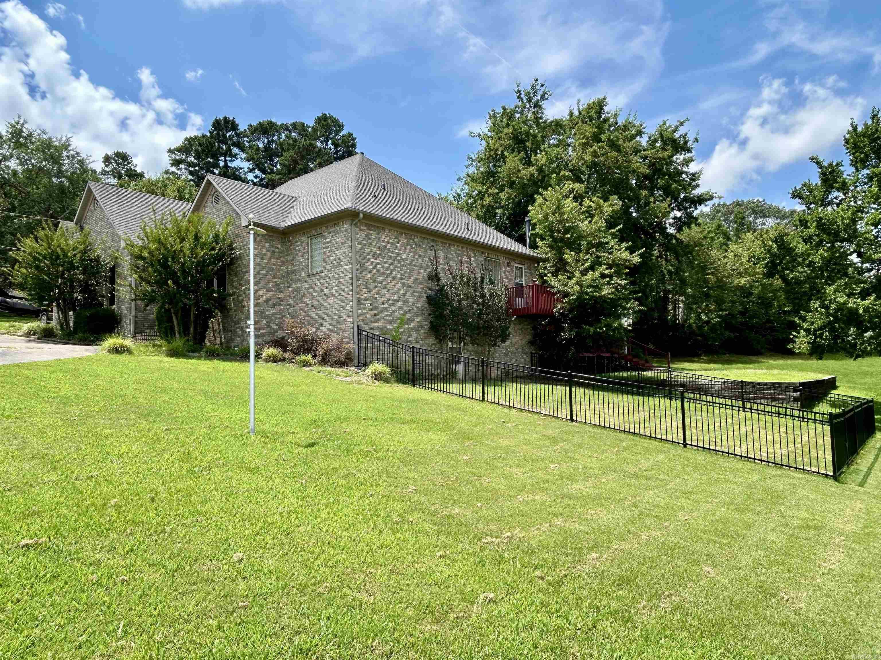 Step into this beautiful well maintained brick 1.5 story home, with large private multi level deck and beautiful yard - perfect place to enjoy morning coffee or a night under the stars! Inside, enjoy a Master Bedroom with a spacious sitting area, large walk in closet, soaking tub and walk in shower. A second main floor bedroom has its own private full bath. The large living room is perfect to entertain or relax, and the layout from the kitchen offers access to a dining area or eat in kitchen. Step down into lower level which has 3rd bedroom or bonus/theatre room featuring its own 1/2 bathroom, access to the fenced yard and equipped with a 'Safe-Room' & alarm system. Tons of storage in a temperature controlled raised crawl space, as well as a full house attic to keep all of your 'extras' safe and out of site. A large 2 car extra deep garage will keep your cars out of the elements and features a small workshop for hobbies or your next DIY project. As an added bonus, there is a 2 bay metal shop with a covered RV port, perfect to store your boat, camper or other toys & equipment. Minutes to schools, shopping, & highway access on .92 of an acre. A country feel with city benefits!