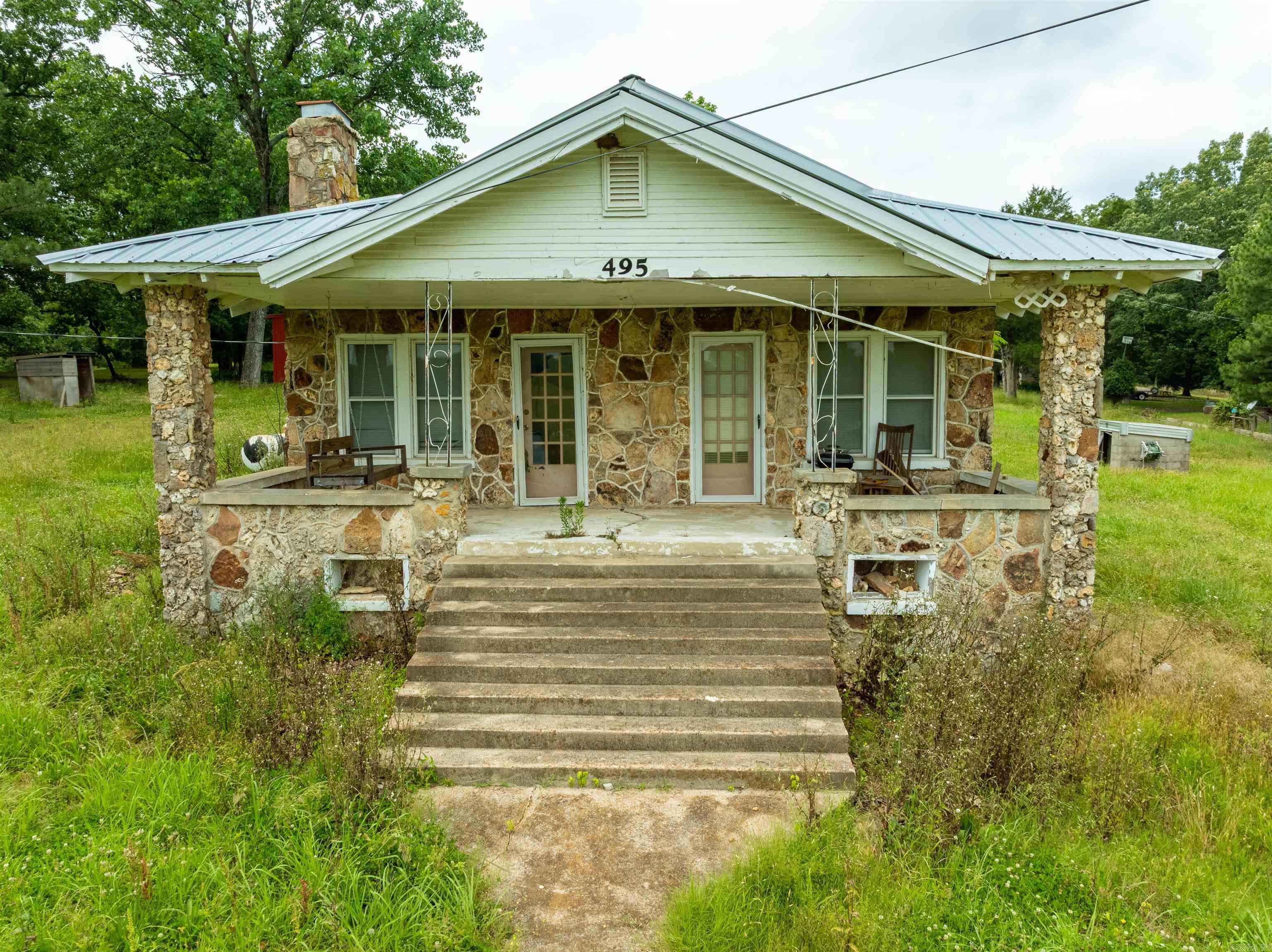 This 3-bedroom, 2-bath home sits on approximately 2 acres and offers great potential with a little TLC. Recent updates per seller include a newer metal roof, a new HVAC unit installed within the last two years, and new laminate flooring in several rooms. The property also features a large barn and a shop building, providing plenty of space for storage or projects. With additional improvements, this property could make an excellent rental investment or a forever home.