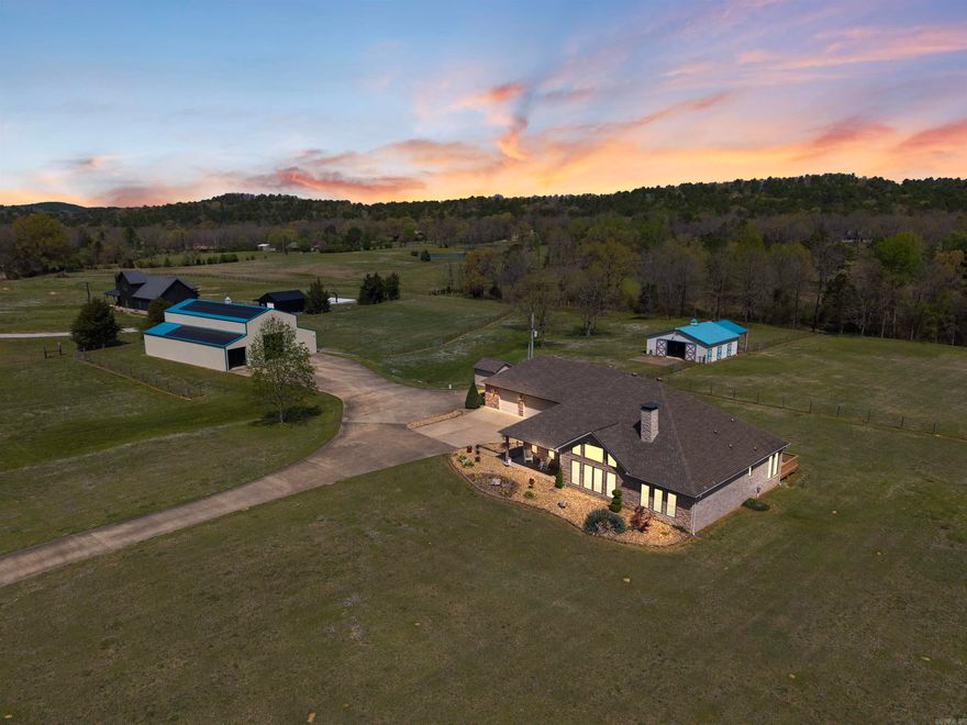 Welcome to peaceful country living on 11 incredible acres with a private gate and fully fenced with sub-fencing. Beautifully renovated one-story home features 3 bedrooms, 2 full bathrooms, an office (or 4th bedroom), sunroom, FEMA-rated safe room, and a 3-car garage. The open-concept great room boasts a vaulted ceiling, fireplace, hardwood floors, built-ins, and a gourmet kitchen with high-end appliances, quartz countertops, walk-in pantry, coffee bar, and wet bar with ice machine. Kitchen appliances include a Thermador Induction cooktop, dishwasher drawers (2), built-in refrigerator and freezer, microwave drawer and double wall ovens. The spacious primary suite includes dual closets and a spa-like bath. The 3,780 sq ft shop offers a kitchenette, full bathroom, laundry service, and space for RVs/cars, hobbies such as pickleball—powered by 66 solar panels keeping electric costs under $15/month for the entire property. The barn includes 3 stalls (with 2 more available), a tack room, and lean-to for equipment. A new well house is in place, with city water expected soon. Comfort, efficiency, and wide-open space all in one!