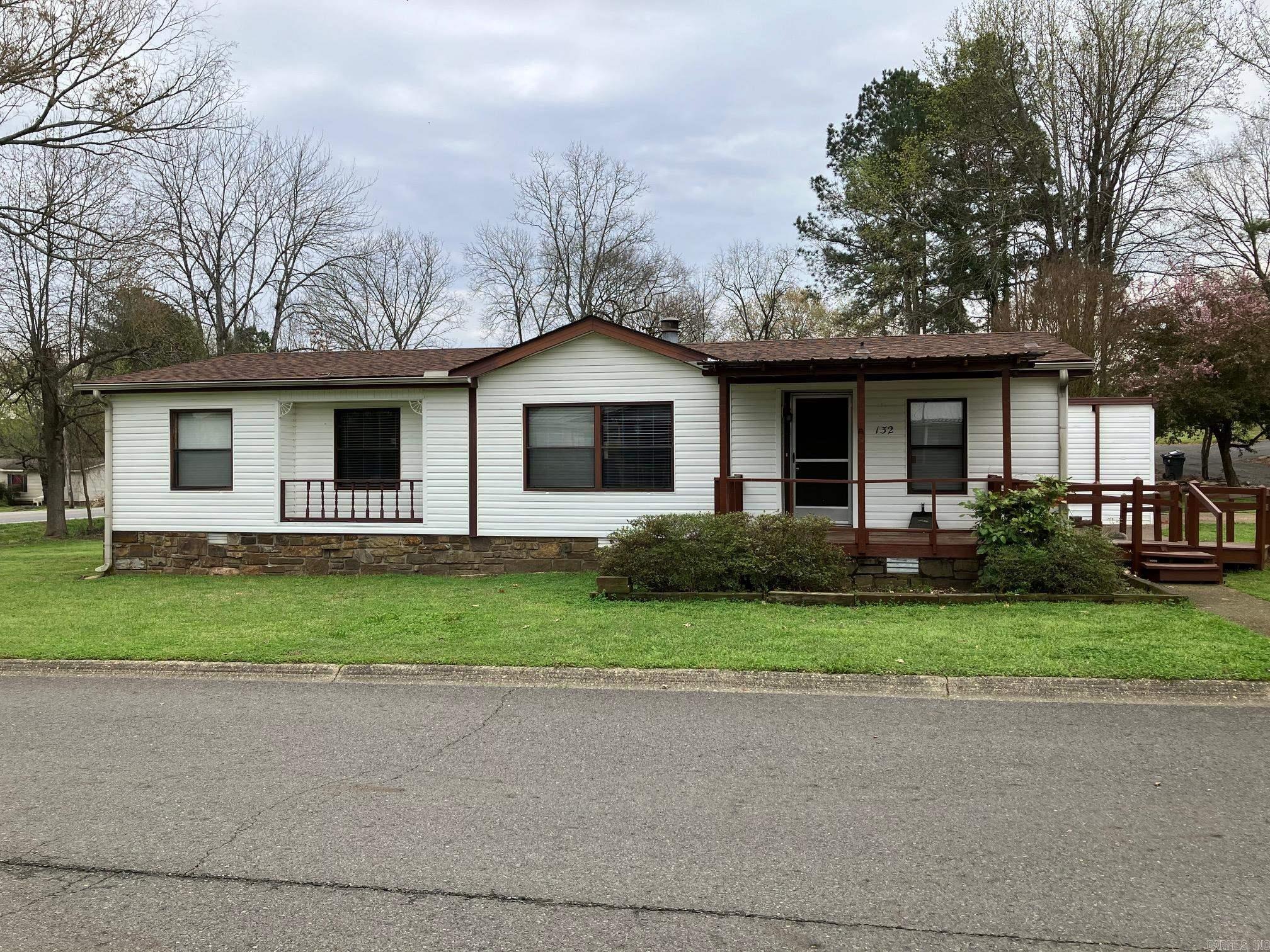 Here is your chance to buy a home in Southwood. 55+ addition home is near the clubhouse and swimming pool. New floors, new roof 2023, newer HVAC. Garage has a workshop and storage area. Front porch and master bathroom are handicap accessible. Screened back porch and fenced dog run. New washer and dryer convey. 1 bath has new sink, toilet, and shower. There is plenty of new flooring to finish the floor in one bathroom. Huge wood-burning fireplace accents the living room. Room added to MH is a home office or could be a 4th bedroom. Beautiful landscaping with rock foundation around the home. With a little paint and TLC this could be your dream home. Great 55+ neighborhood with low monthly HOA fee near shopping, restaurants, and entertainment. If this sounds like what you are looking for, set up an appointment to view. At this price, it won't be on the market long.