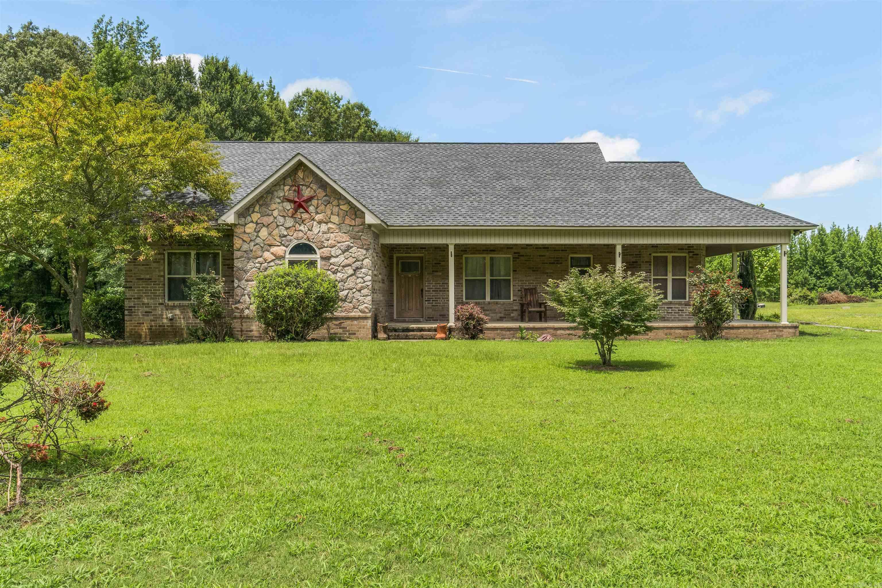 Outside the city limits of Bald Knob, sits a place that already feels like home. This ranch-style home stretches out over 5 acres of good olā Arkansas ground- flat, green, and full of life. Built on a slab and nearly 2,000 square feet, itās got all the space you need and the kind of front porch that wraps around like a big country hug! The layout is as functional as it is inviting... with a cozy kitchen that includes a pantry, a separate dining area for family dinners, tray ceilings in the large primary bedroom and spacious living area, gas fireplace, and two back doors. You'll find storage tucked where you need it, space to spread out, and that rare kind of peace you can't buy in town. Whether itās rocking chairs on the porch, kids running barefoot through the grass, or just you and a strong cup of coffee watching the fog roll in... this place fits the life youāve been dreaming of. If youāve been waiting on the right one- the one that feels like home the moment you turn down the driveway- this might be the one for you! Newer Roof (2023) Original HVAC (2009) Minerals rights do not convey. FEMA-approved safe room.