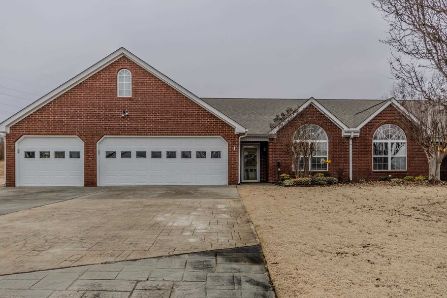 Stunning Updated Condo with Open Floor Plan and Sunroom! Step into this beautifully renovated spacious condo featuring bright, crisp white cabinetry that compliments the gorgeous granite countertops and large island in the open concept kitchen and living area. The inviting sunroom offers the perfect spot to relax and soak in natural light. The primary suite is a true retreat with a large custom tile shower, huge closet, and stylish shiplap accent walls. Enjoy peace of mind with a newer HVAC and roof. With a three car garage perfect for your vehicles and golf cart, this home is as functional as it is beautiful. Don't miss out on this move in ready gem!