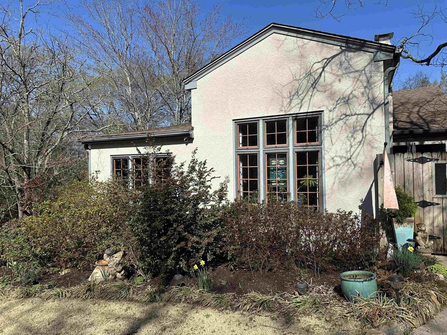 Uptown Charmer! Mediterranean-style 3 bed/2 bath with an easy, flexible floor plan — TV den and eat-in kitchen open to the main kitchen, with separate formal dining and living rooms. True to its 1930s era roots, the home honors the original architecture with plaster coved ceilings and soaring 11½-foot ceilings in the formal living room, complete with a gas log fireplace and custom silk drapes. Step outside to a beautiful, tranquil patio full of charming character details — including piano notes worked into one of the gates, a sweet nod to the home's storied past. Carport included, along with an extra lot at 202 Wren Street. Updates include a new roof, HVAC, tankless water heater, gas lines, and new electrical.