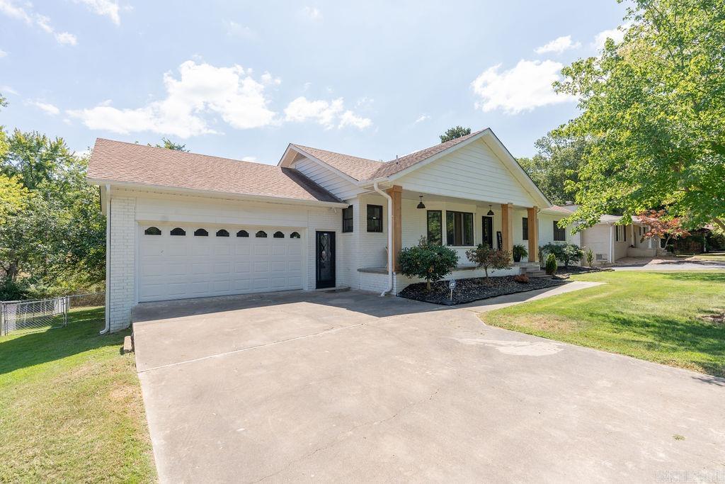 This home offers a beautifully remodeled 3 story home with modern updates that includes 2 kitchens, new appliances, new flooring, 2 heating/air units, all bathrooms have luxurious ceramic tile, added square footage for media/bonus room on 3rd floor with mini split heating/air plus a garage. Main floor has 3 bedrooms and 2 full luxury walk-in showers. Lower level has second kitchen, wet bar, open concept living room, game area, 3 bedrooms and 1 bath including an extra large storage area that would work well as a safe room or add more beds. Sit on the deck to enjoy the large back yard with Greers Ferry Lake being only minutes away. Ideally located in a desirable neighborhood in town and only 6 minutes from the nearest marina. This stunning home could easily house 2 families or use for in-law suite.