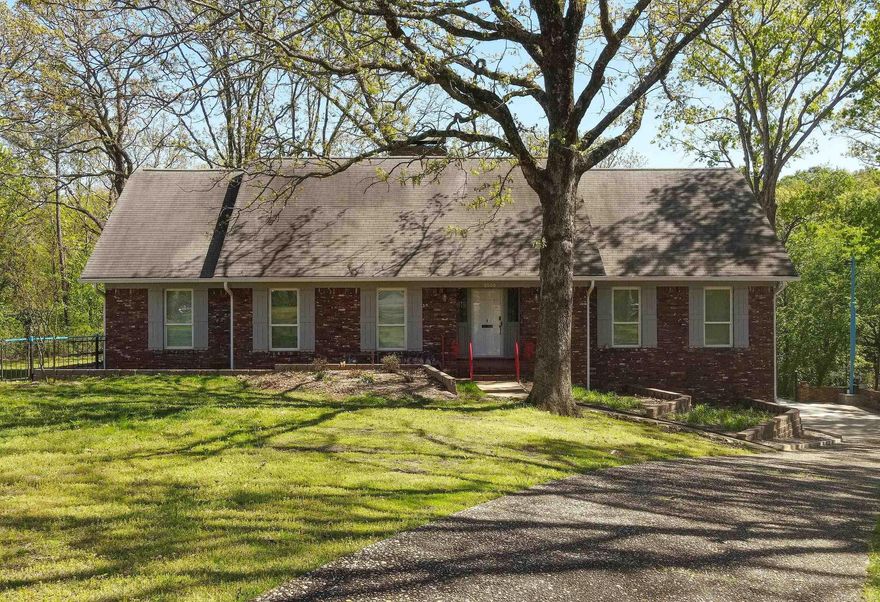 Tucked away on a quiet cul-de-sac, this beautifully updated lakefront home sits on 0.78 acres with a peaceful creek along the back and scenic views from nearly every window.  Inside, enjoy new carpet and flooring, fresh paint, new windows, and a fully renovated kitchen and bathrooms with modern finishes. Multiple living spaces include a heated and cooled sunroom, a cozy den with a wood-burning stove, and a versatile downstairs bonus room—perfect for a home office, media room, or guests.  Additional features include a tankless hot water heater, whole-house water filtration system, and exterior storage. This move-in-ready home combines modern updates with an unbeatable setting—perfect for those seeking comfort, beauty, and a connection to nature.