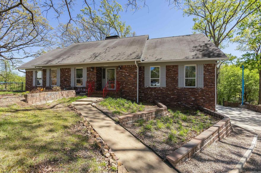 Tucked away on a quiet cul-de-sac, this beautifully updated lakefront home sits on 0.78 acres with a peaceful creek along the back and scenic views from nearly every window.  Inside, enjoy new carpet and flooring, fresh paint, new windows, and a fully renovated kitchen and bathrooms with modern finishes. Multiple living spaces include a heated and cooled sunroom, a cozy den with a wood-burning stove, and a versatile downstairs bonus room—perfect for a home office, media room, or guests.  Additional features include a tankless hot water heater, whole-house water filtration system, and exterior storage. This move-in-ready home combines modern updates with an unbeatable setting—perfect for those seeking comfort, beauty, and a connection to nature.