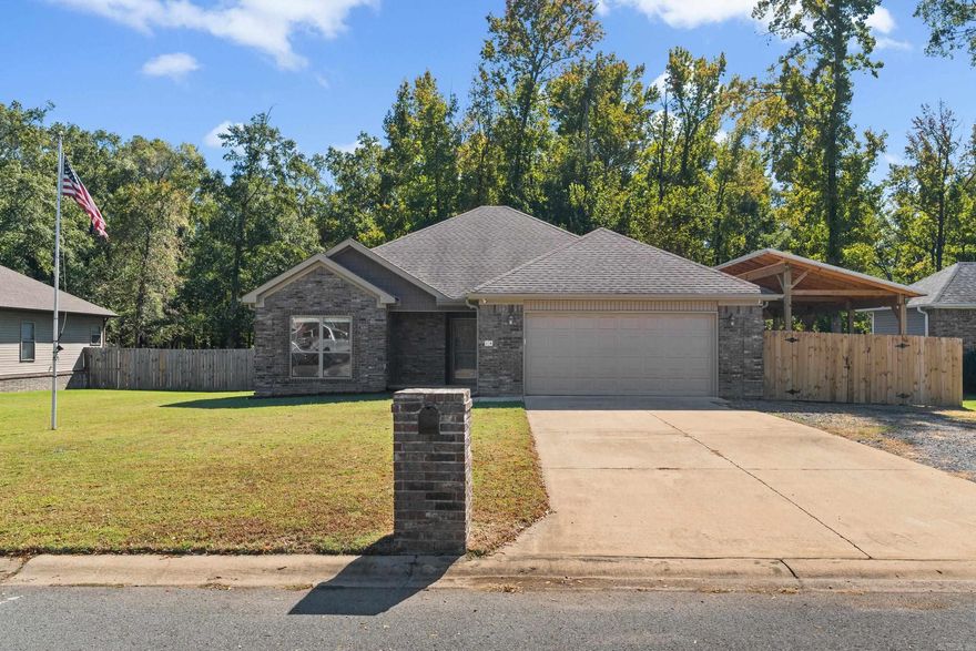 Welcome home to this beautifully maintained 3-bedroom, 2-bathroom residence featuring 1,491 sq. ft. of comfortable living space!  Enjoy upgraded tile flooring throughout and an open-concept layout perfect for everyday living and entertaining.  Vaulted ceiling in the main living area. The kitchen has a pantry, tons of trim, and custom cabinets. Spacious primary suite is privately located and boasts an updated tile shower, his/her vanity sinks & his/her closets. Step outside to a backyard designed for both relaxation and functionality-complete with a 10X18 concrete covered patio, plus a concrete pad area wired for speakers, a pergola, and a dedicated fire pit area.  The fenced yard also includes a separate dog run and a 12X24 outbuilding with insulation, electrical, and AC-ideal for a workshop, home gym, or studio (electrical work permitted). This backs up to a green space overlooking a city park.  A 16X50 carport lean-to provides additional covered parking or storage and is fully fenced with a gate for privacy.  This property truly offers a perfect blend of comfort, convenience, and versatility!