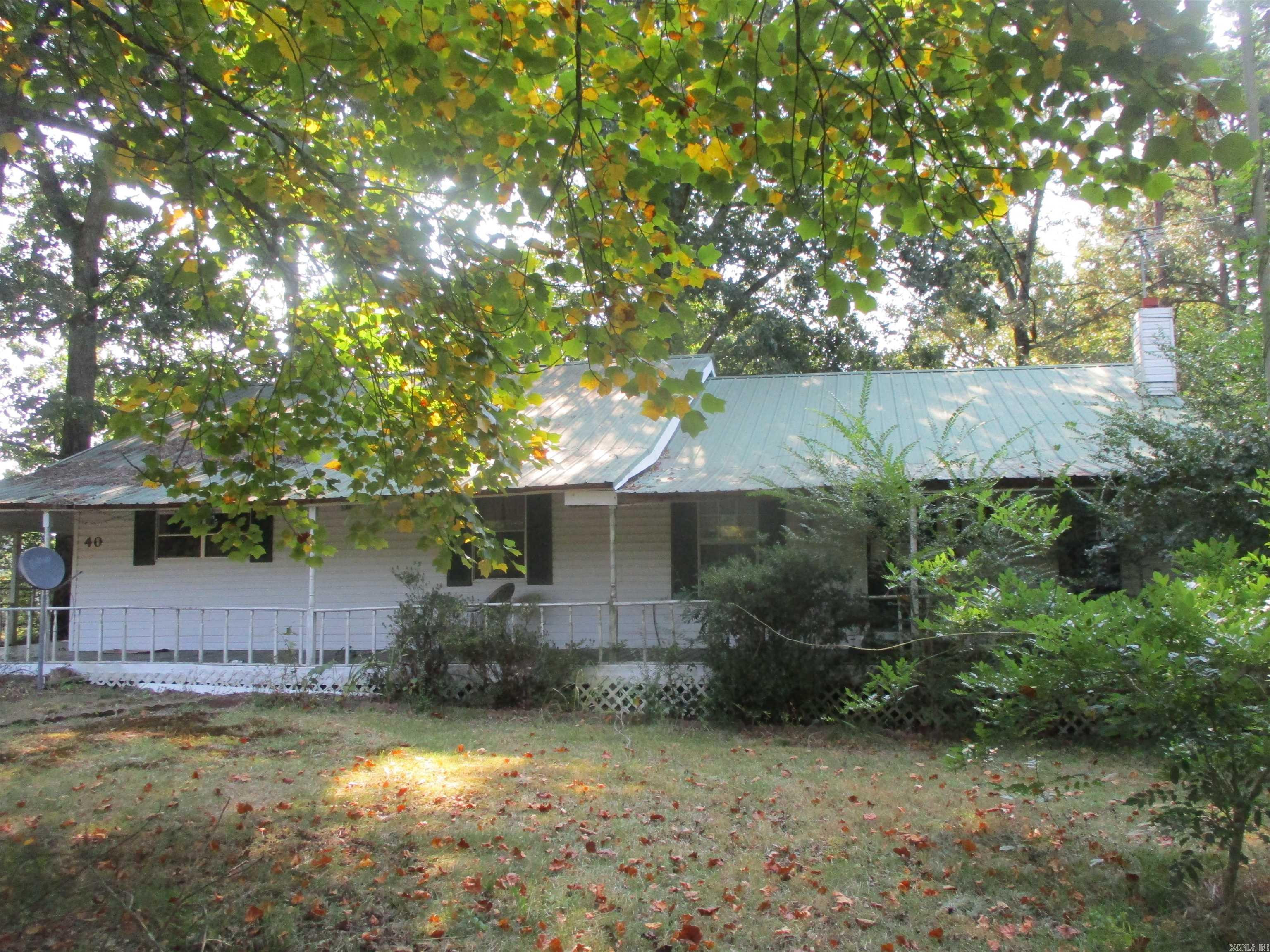 Home for sale in Perryville AR with 3 bedrooms, 2 bathrooms, detached garage shop and covered porch on almost an acre. Sold as is where is.