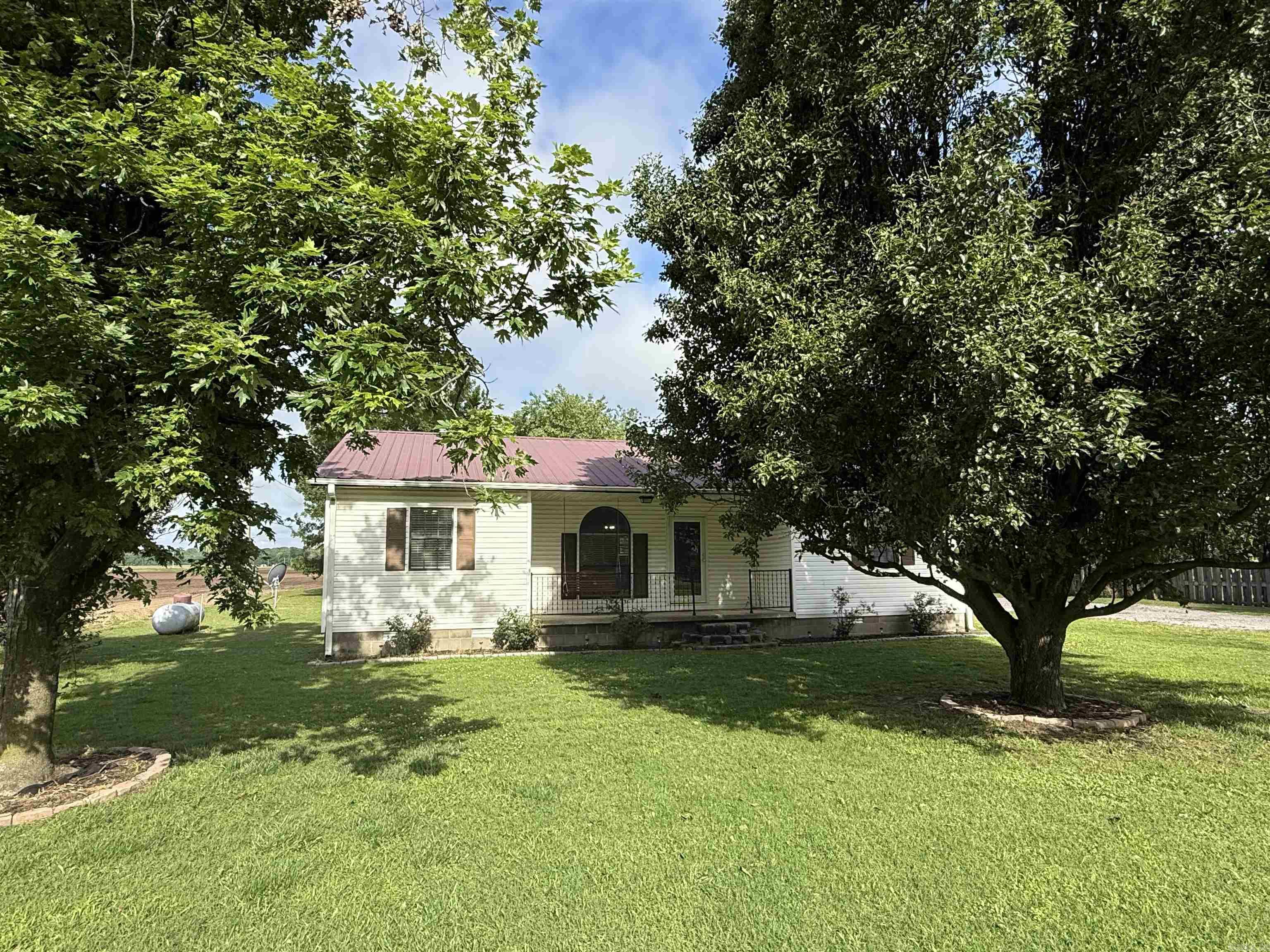Move-In Ready 3 Bed, 2 Bath on 1/2 Acre with Shop & Updates! Enjoy space, comfort, and functionality in this 1,614 sq. ft. home on a 0.5-acre lot. Recently updated just 3 years ago, it features a large primary suite with an oversized bathroom and walk-in closet, metal roof, and a spacious laundry room. The kitchen offers a modern two-tone cabinet design with white uppers, gray lowers, and includes the fridge. Outside, relax on the back deck or take advantage of the wired 20x25 shop with lien-to and a separate wired outbuilding complete with mini split, perfect for hobbies or extra workspace. Plenty of room to live, work, and unwind. Schedule your showing today!