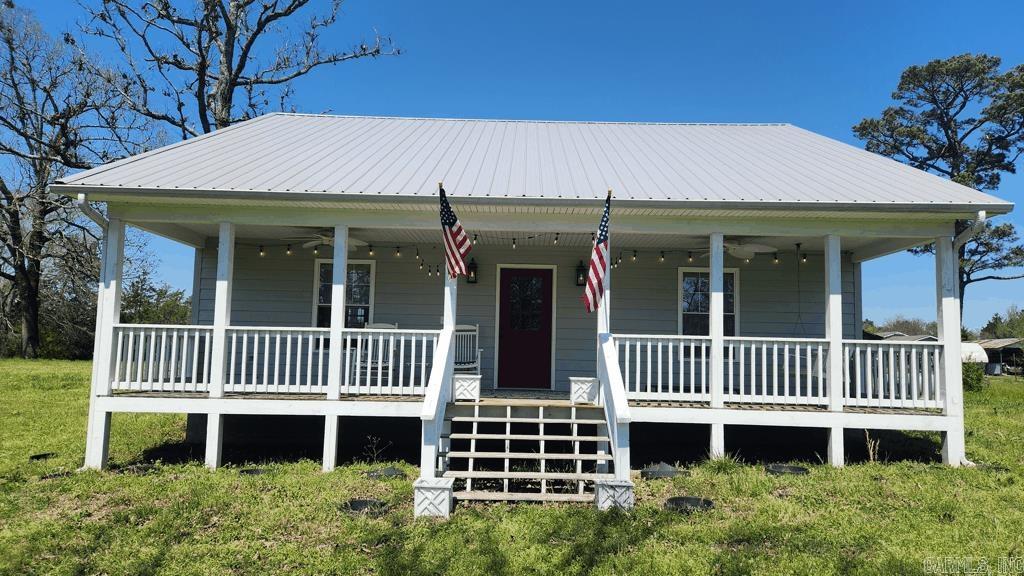 Built in 2021, this 2 bedroom 1 1/2 bath farmhouse in Story AR with 1596 square feet living space is perfect for the retirement era of your life or the beginning of the simple life. Everything is new/barely used. Quartz counter tops, laminate flooring throughout, covered porch on the front and the back for lots of out door time, gas range, gas logs, on demand water heater, and a dishwasher are some of the features of this home. The 1.88 acre tract is easy to maintain and fenced. Lots of natural light. Current survey. Well and septic. Central heat and air. There is a barn for storage. And at certain times of the year, there is a nice view of the Muddy Creek Wildlife Management Area. Only 4 miles to Lake Ouachita.