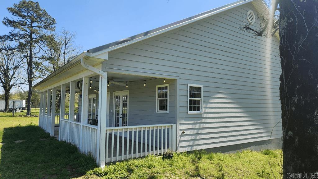 Built in 2021, this 2 bedroom 1 1/2 bath farmhouse in Story AR with 1596 square feet living space is perfect for the retirement era of your life or the beginning of the simple life. Everything is new/barely used. Quartz counter tops, laminate flooring throughout, covered porch on the front and the back for lots of out door time, gas range, gas logs, on demand water heater, and a dishwasher are some of the features of this home. The 1.88 acre tract is easy to maintain and fenced. Lots of natural light. Current survey. Well and septic. Central heat and air. There is a barn for storage. And at certain times of the year, there is a nice view of the Muddy Creek Wildlife Management Area. Only 4 miles to Lake Ouachita.