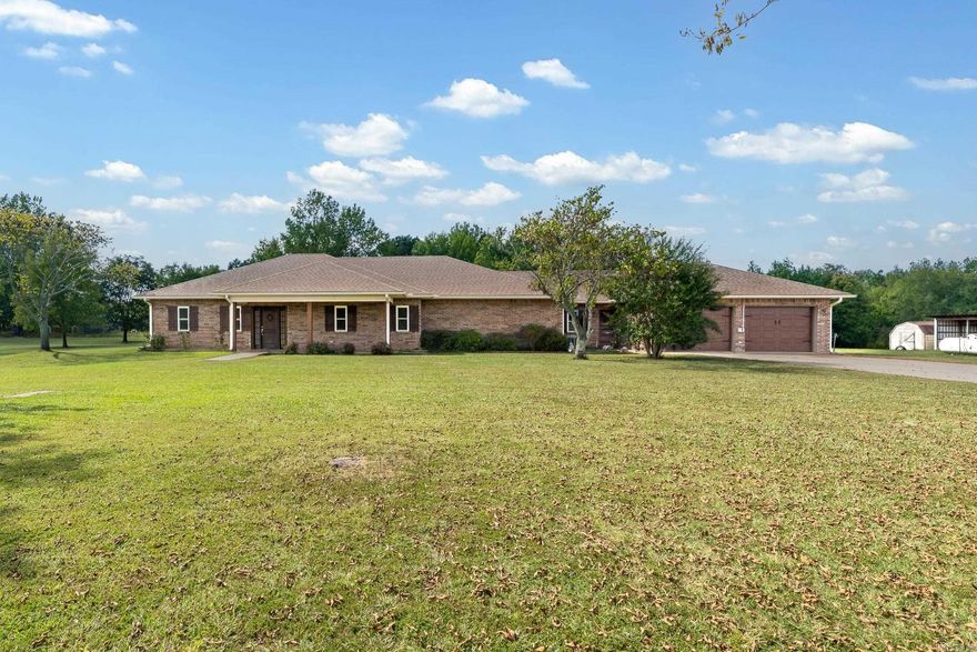 Spacious Country Living Just Minutes from Town! Welcome to your dream home in the heart of the beautiful Ouachita Mountains, just outside the charming town of Mena! This stunning 3-bedroom, 2.5-bath home offers the perfect blend of comfort, style, and space — all on 6 fully cleared and meticulously maintained acres. Step inside to discover a bright and open layout featuring:A large, beautifully tiled living room perfect for relaxing or entertaining. A spacious kitchen with granite countertops and a dedicated dining area.A massive multi-purpose room ideal for a home office, game room, den, or all of the above.A huge walk-in closet and stylish finishes throughout.Fresh interior paint and a brand new roof for peace of mind.You’ll love the 4-car drive-through garage — fully heated and cooled — with a convenient laundry area and plenty of space for your vehicles, workshop, or hobbies. Step outside and enjoy: A covered patio perfect for morning coffee or evening gatherings, A tranquil waterfall feature that adds a touch of serenityA storage shed ideal for mowers, tractors, ATVs, or whatever you need. Wide-open, level acreage with endless possibilities — all just minutes from town.