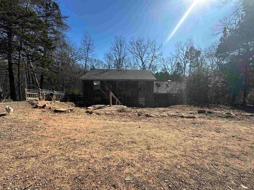 Have you been looking for a home to homestead and the ability to work remotely? From wet weather creek, fruit trees, berry bushes, and many more possibilities.  Large back deck to entertain, grill or just kickback and relax. Primary bedroom on main level, 2 bedroom and a bonus room/office upstairs with full bathroom. 24x30 shop and 10x16 outbuilding/chicken coop. Large laundry room/pantry. Man cave under the house also used as safe room with natural rock that gives a little extra charm. All this sitting on 5 Acres M/L. Call today for your viewing appointment. Let's make it yours. Agents see remarks.
