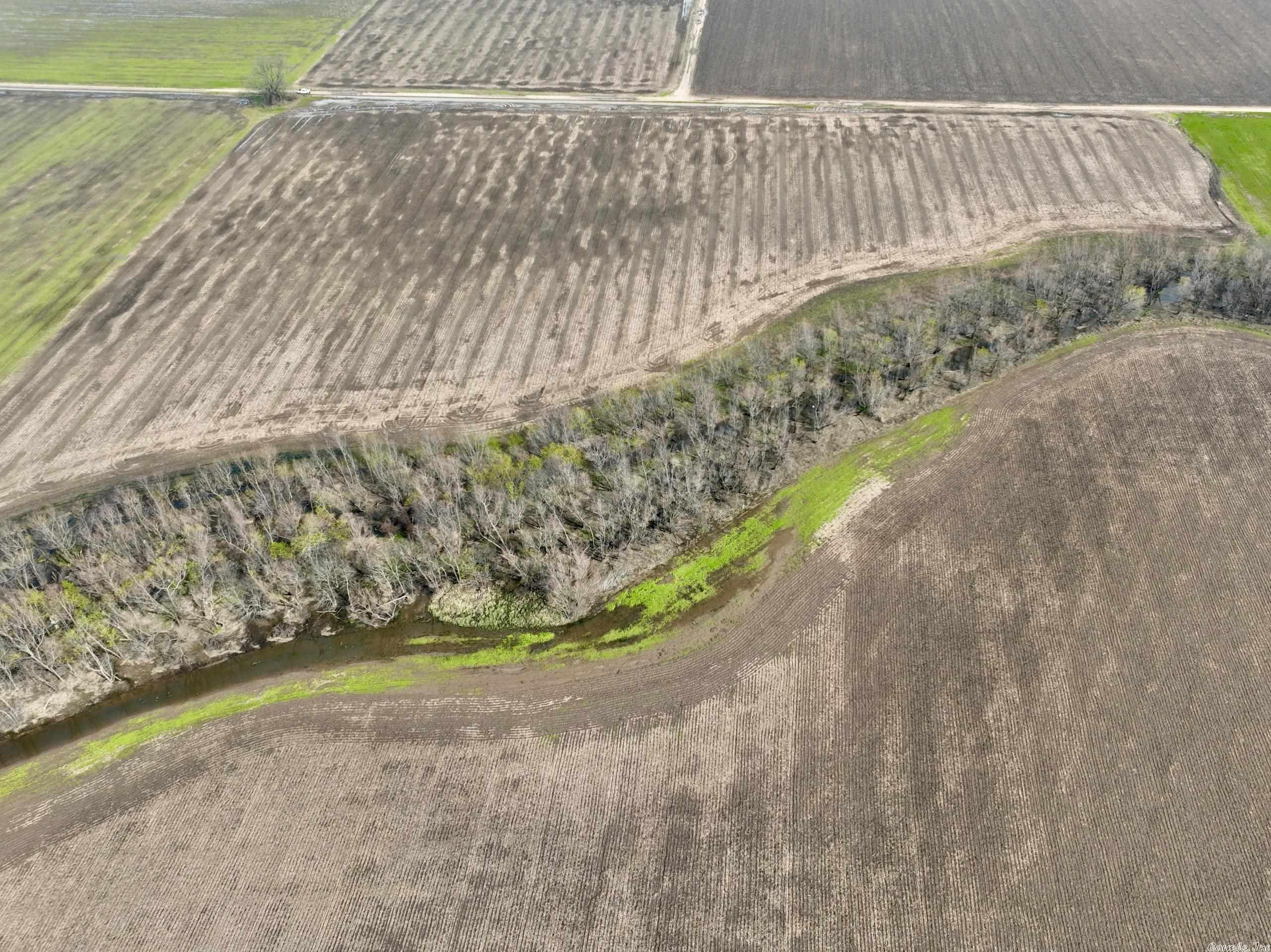 This property truly represents a once-in-a-lifetime opportunity to own a piece of the original American Dream. Located in the heart of the River Valley, this stunning piece of land boasts an impressive array of features that are sure to impress even the most discerning buyers. One of the most compelling aspects of this property is its potential for income-producing tillable acreage. With rich, fertile soil and ample water resources, this land is ideally suited for a wide range of agricultural activities to include row crop production. And with its proximity to the town of Dyer and easy access to major highways like I-40, it's perfectly positioned to take advantage of the growing demand for locally sourced, sustainably grown food. But that's just the beginning. This property also offers unparalleled hunting opportunities, with an abundance of deer and duck sign throughout. The Crooked Slough runs right through the heart of the land, providing prime habitat for waterfowl and other wildlife. And with its proximity to the Frog Bayou Wildlife Management Area and the Arkansas River, hunters will have no shortage of options when it comes to pursuing their passion.