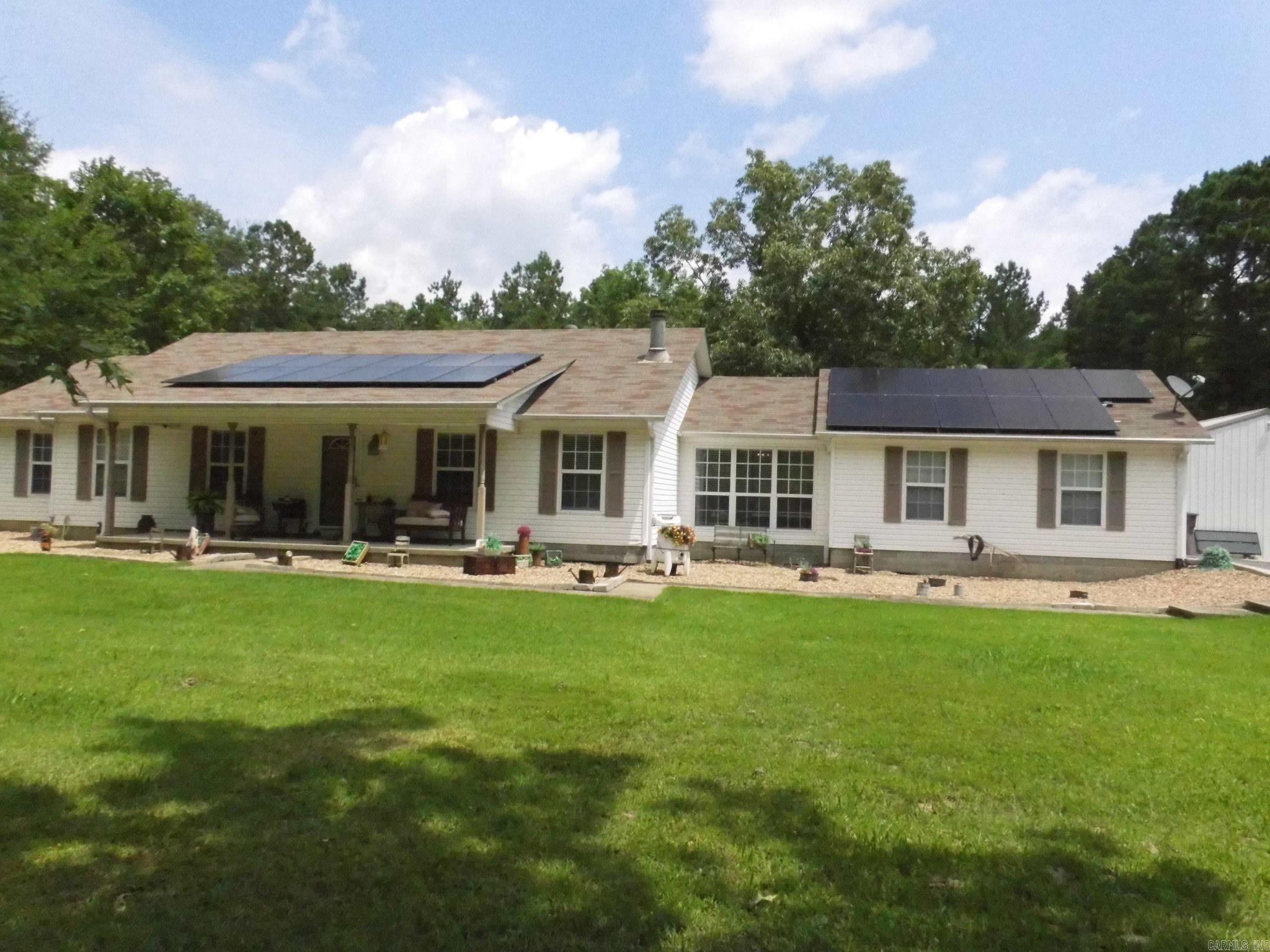 **Beautifully updated country home sitting on 5 acres**Conveniently located just 15 minutes from Little Rock**Updates include interior painting, Luxury vinyl flooring throughout**Kitchen has new granite countertops, sink, touch faucet, double oven, propane cookstove**2 pantries, slide-out trash bin, slide out deep drawers, and breakfast bar**Living room has vaulted ceiling and new tiled wood burning fireplace **Both bathrooms have new granite countertops, sinks/faucets, toilets and shower/tub**Master bath has tiled walk-in shower and double vanities. master suite has his double closet and her walk-in closet**Guest bedrooms have walk-in closets**Exterior features an insulated 30 x 30 shop with electricity and 50 amp RV hookup**Covered back patio with 3 ceiling fans is great for entertaining**Additional portable carport**Fenced backyard**New roof in 2019**Solar panels are a huge savings on Electric bill (they will be paid off at closing)**See associated documents for additional info regarding updates and electric costs**
