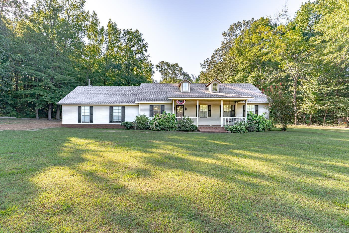 Welcome to Market 9028 Old Military Lane of Harrisburg, Arkansas. Calling all team ropers, barrel runners, and nature enthusiasts. This exceptional 20 +/- surveyed acres on scenic Crowley’s Ridge offers the perfect blend of country living and equestrian excellence. The property features a 1,400 sf +/- Ranch style house, 150 x 220 riding arena w/ lighting, 36 x 60 barn w/ 10 stalls, tack room, and electric, 30 x 30 wired shop, and 3 bay lean-to for hay, 15 x 40 concrete pad, 5 hydrants, 3 +/- acres of fencing, seasonal creek, and side entry 2 car heated & cooled finished garage. The well maintained home is wrapped in brick & vinyl, topped w/ architectural shingles and accented by shutters. The interior features 3 bedrooms, 2 bathrooms w/ shower tub combo, kitchen w/ bar seating & pantry, dining area, living room, and laundry room. You'll love the fiber Internet by Empower, fresh paint, laminate flooring, quartz countertops, front porch, covered back patio, and gorgeous landscaping. Conveniently located just 20 miles to Jonesboro, 60 miles to Memphis and just minutes from world renowned duck hunting. Call today to schedule your tour and make this one of a kind estate your own.