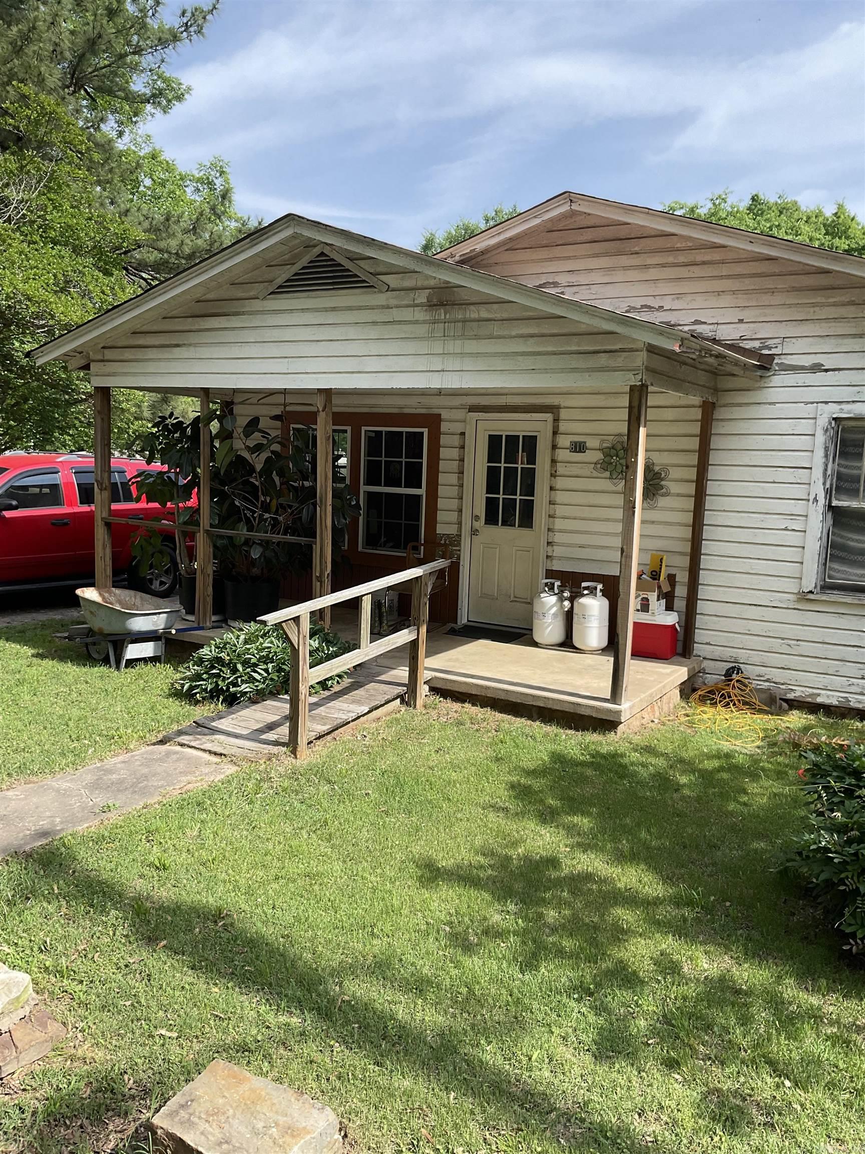 FIXER UPPER ON NEARLY AND ACRE-ENDLESS POTENTIAL!!! Situated on a spacious corner lot of 3/4 acre, this 2 bedroom, 1 bath home is full of potential for the savvy buyer or investor. The property features a large kitchen, perfect for future updates, and a covered back porch ideal for relaxing or entertaining. The entire back and side yards are fully fenced, making it great for pets, gardening, or outdoor living. Two separate storage buildings provide ample space for tools, hobbies, or equipment. With room to expand and customize, this property is a rare opportunity to create your dream home or investment on a generous lot.