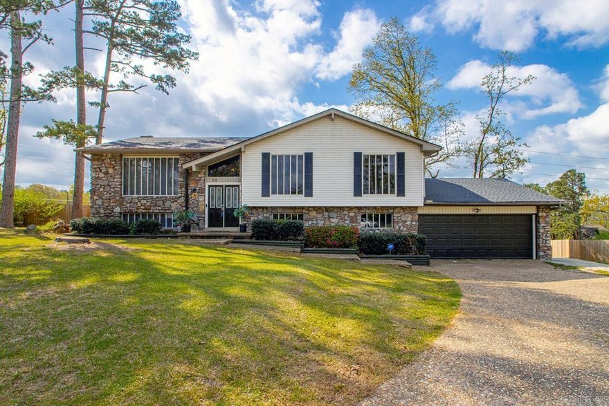 This inviting home features a cozy fireplace, a stunning kitchen with a large island,  seamlessly open to the dining and living areas creating an ideal space for both everyday living and effortless entertaining. Recent updates throughout the home include new flooring, fresh paint, modern light fixtures, and beautifully updated stairs. The expansive back deck spans the entire width of the house, offering a nice view and a perfect setting for outdoor relaxation. Abundant natural light floods the interior, enhancing the bright and welcoming atmosphere. Situated on a quiet cul-de-sac, this home provides privacy and tranquility. Additional highlights include a brand-new roof (2023) and a new deck (2023). The thoughtfully designed layout offers two separate living spaces along with a spacious game room, providing flexibility and room for the whole family to enjoy.