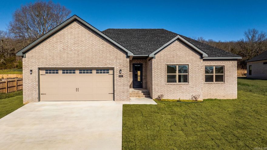 Great plan! Has a large living room with lots of windows open to the kitchen. Electric fireplace is great focal point on the wall.  Nice sized island in the kitchen with cabinetry in the island. Big pantry! Electric fireplace. Primary bedroom has box ceilings for extra height.  Guest rooms are separate from the primary bedroom. Tile showers in bathrooms. Fantastic porch across the back of the home.