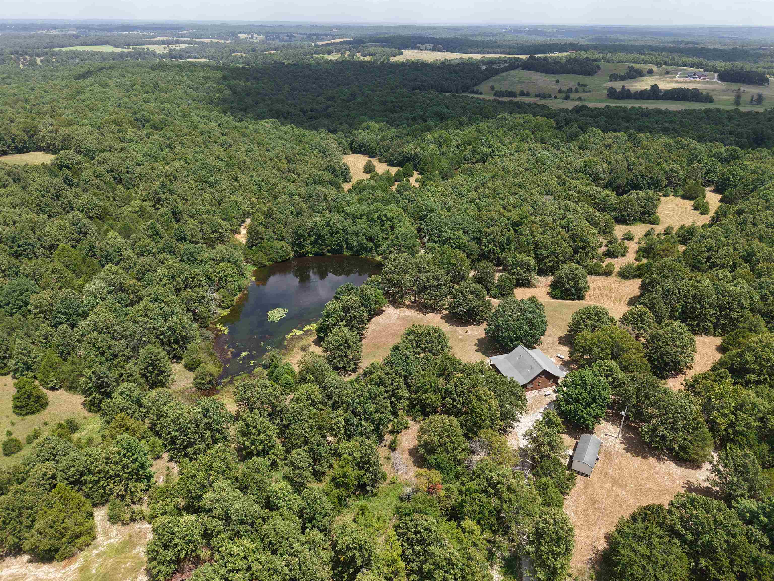 Escape to the Ozarks with this stunning custom log home for sale in Arkansas, perfectly situated on 55 +/- unrestricted acres of private, recreational land. This 3-bedroom, 2-bathroom home features a spacious loft, custom home design, and an unfinished basement with expansion potential- spanning approximately 2,476 total square feet of living space. The property includes a charming wrap-around porch overlooking a beautifully landscaped yard. There are two stocked ponds and an established trail system that offers endless opportunities for fishing, hiking, ATV riding, and exploring the outdoors. Located on a private road, this secluded property is a haven for wildlifeāideal for hunting, nature watching, or simply enjoying the rural scenery. Whether you're searching for a private homestead, a hunting retreat, or a country getaway home, this property offers it all- listed for only $359,900! Donāt miss your chance to own this beautiful piece of Arkansas real estate!